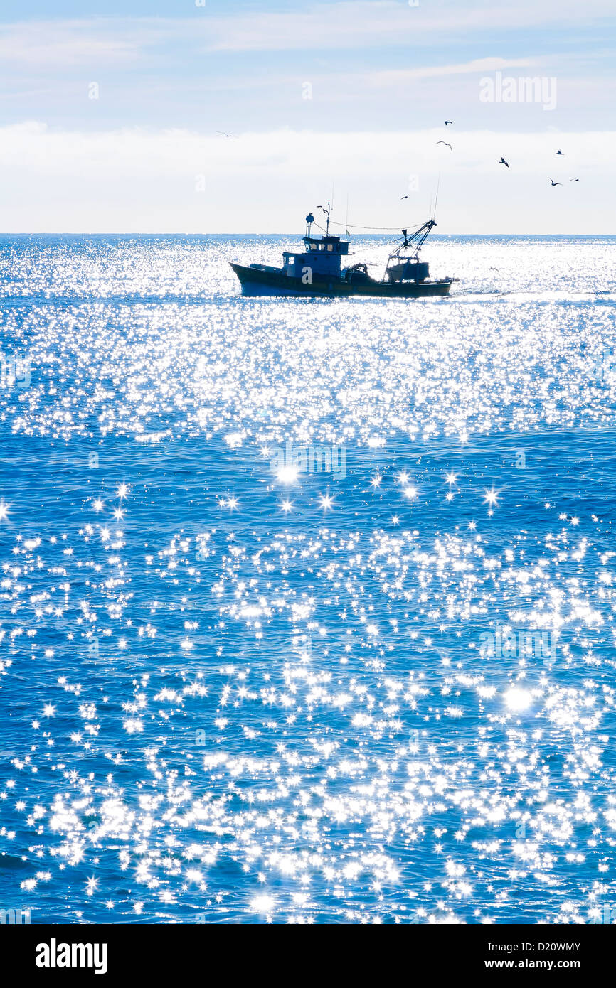 A fishing boat on the blue sea Stock Photo - Alamy