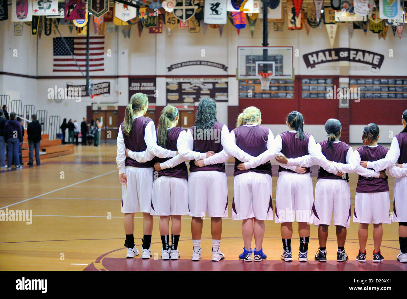 Teammates link arms during the playing of the Star Spangled Banner prior to the start of their game. USA. Stock Photo