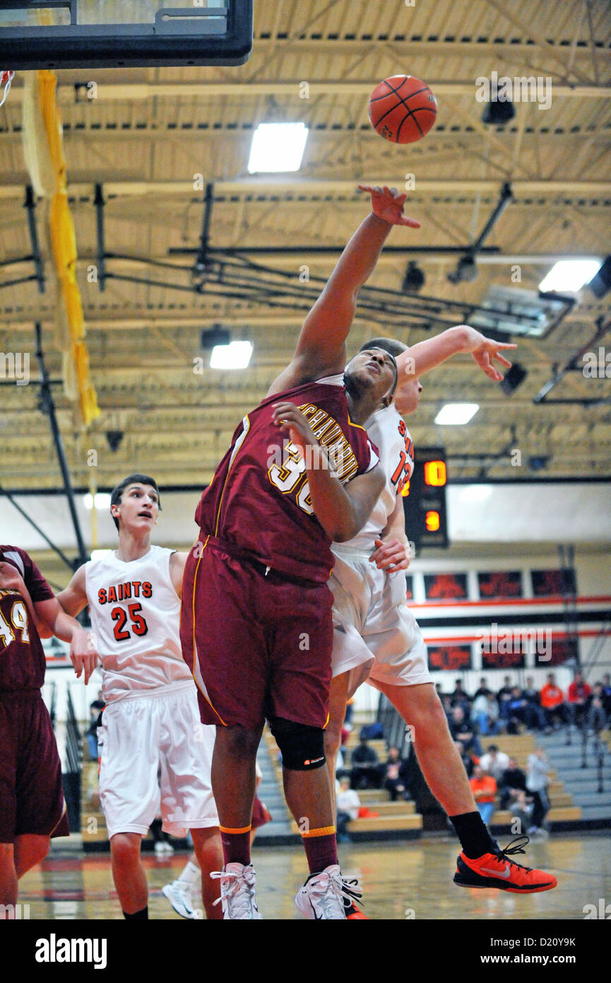Sport Basketball Players battle for a rebound during a high school game