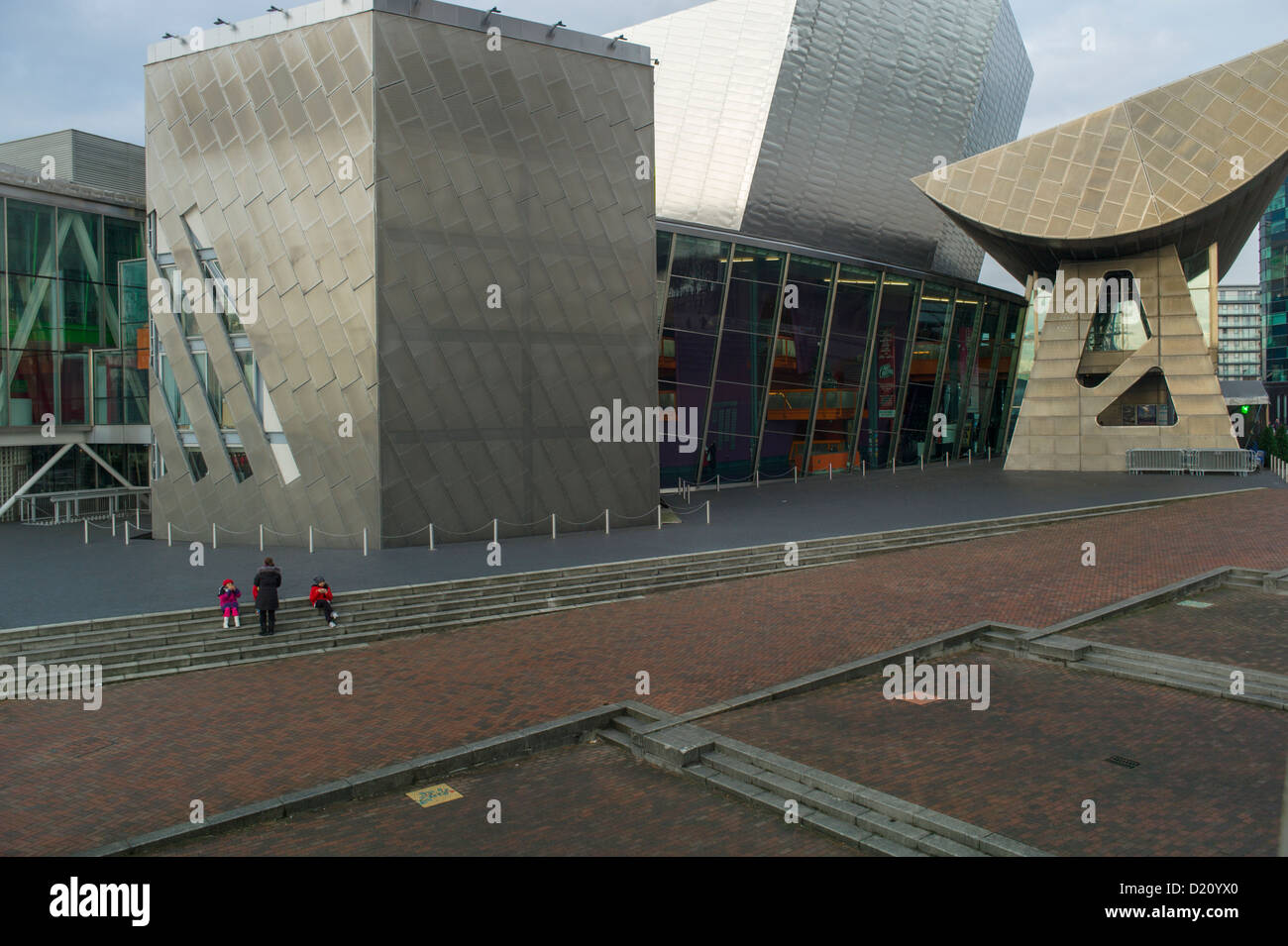A family having lunch at the Lowry Centre Architects: James Stirling, Michael Wilford Stock Photo