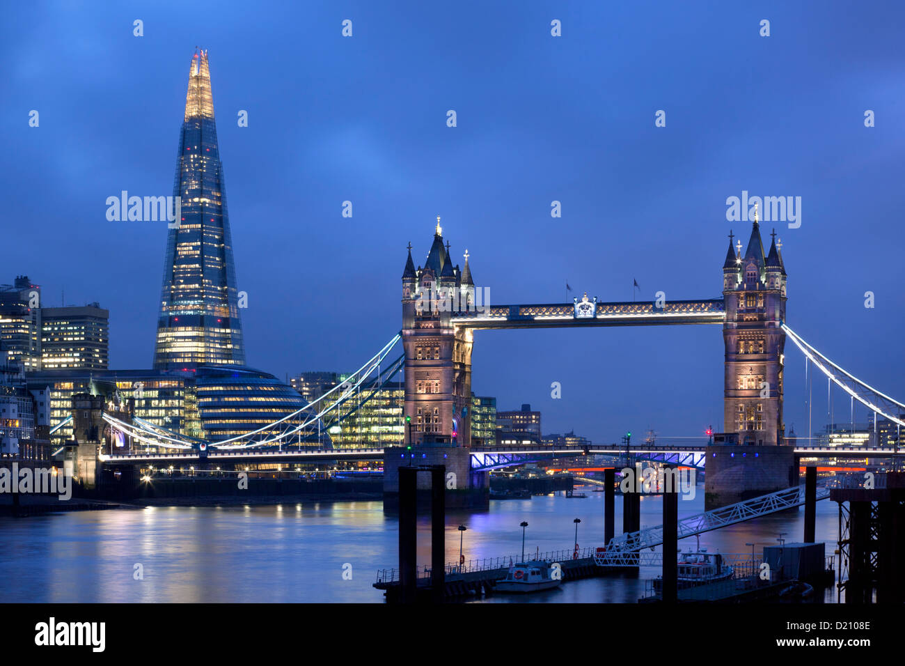 View along river Thames with Tower Bridge and new Shard Building at night, London, England, Europe. Stock Photo