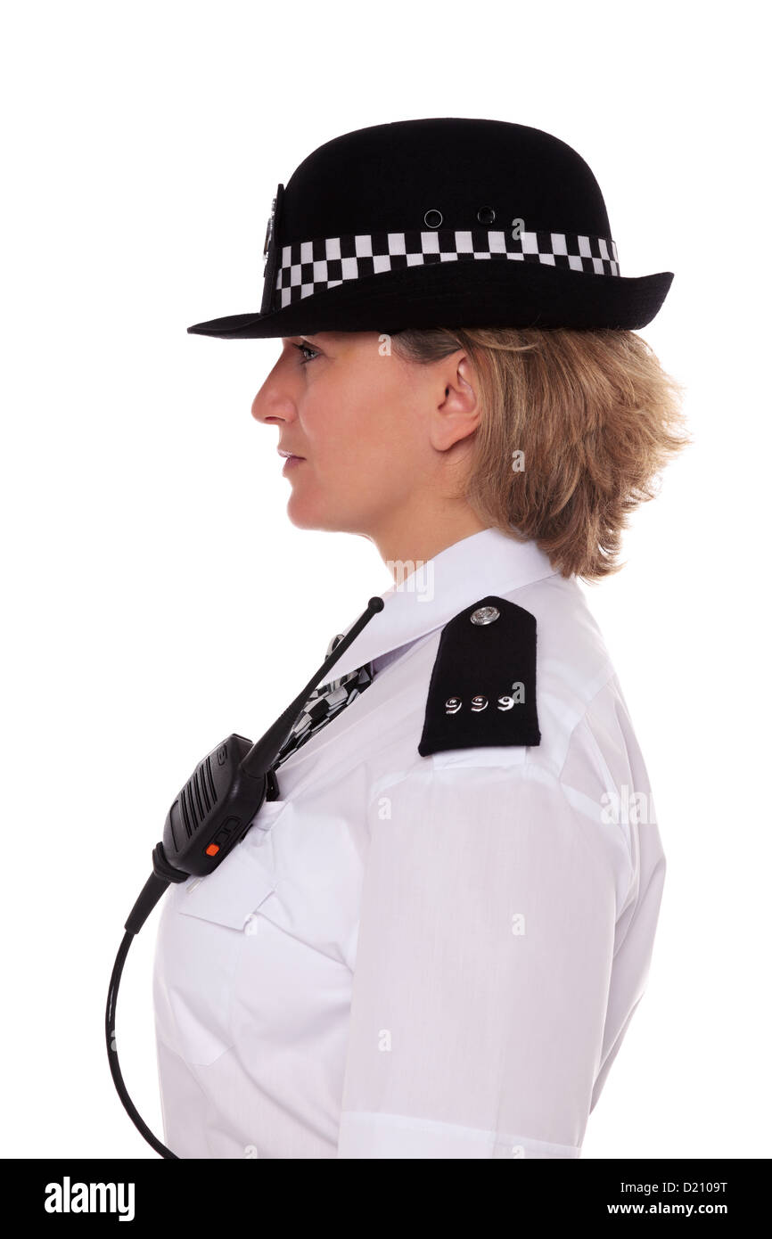 Studio shot of a female British Police officer in uniform, side profile showing her epaulettes and radio mic. Stock Photo