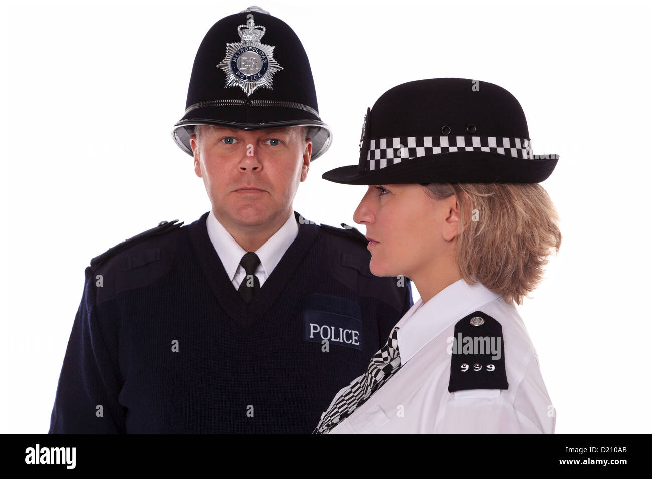 Studio shot of male and female British Police officers in traditional uniform. Stock Photo