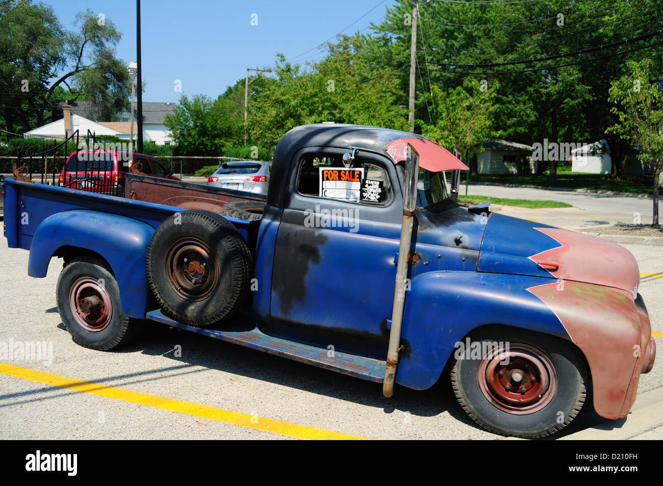 Skokie, Illinois, USA. Colorful, antique 1956 International pickup truck sits in a lot with a for sale sign. Stock Photo