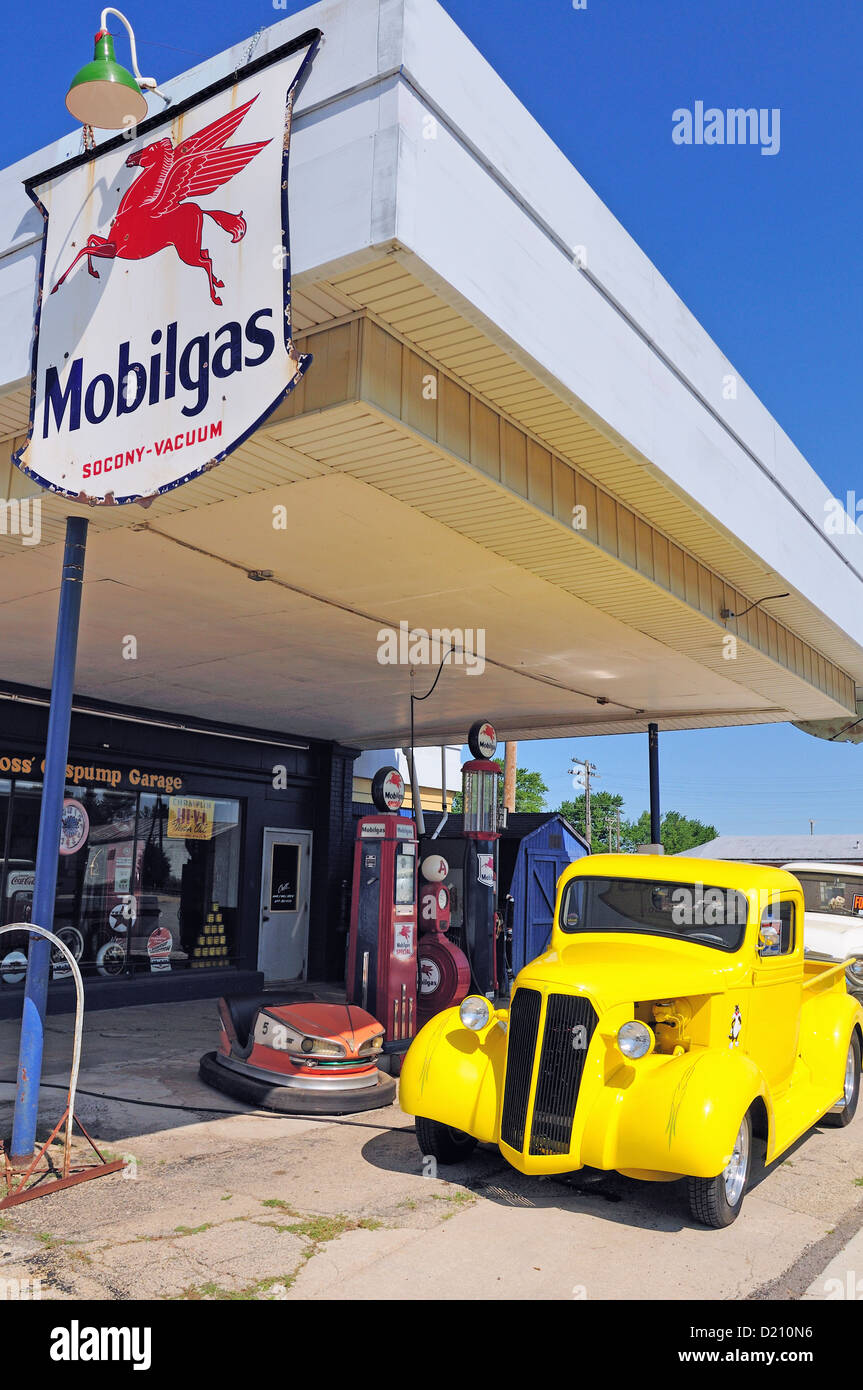 USA, Hampshire, Illinois. vintage service station in rural Illinois features historic gas pumps along with vintage pickup trucks on sale Stock Photo