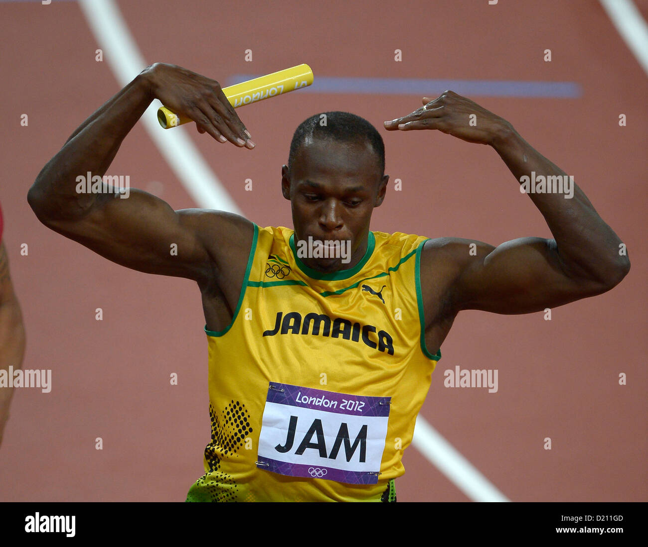Jamaica's Usain Bolt does a 'mo farah' salute after he crosses the line in first place in the mens 4x100m final. Athletics Stock Photo