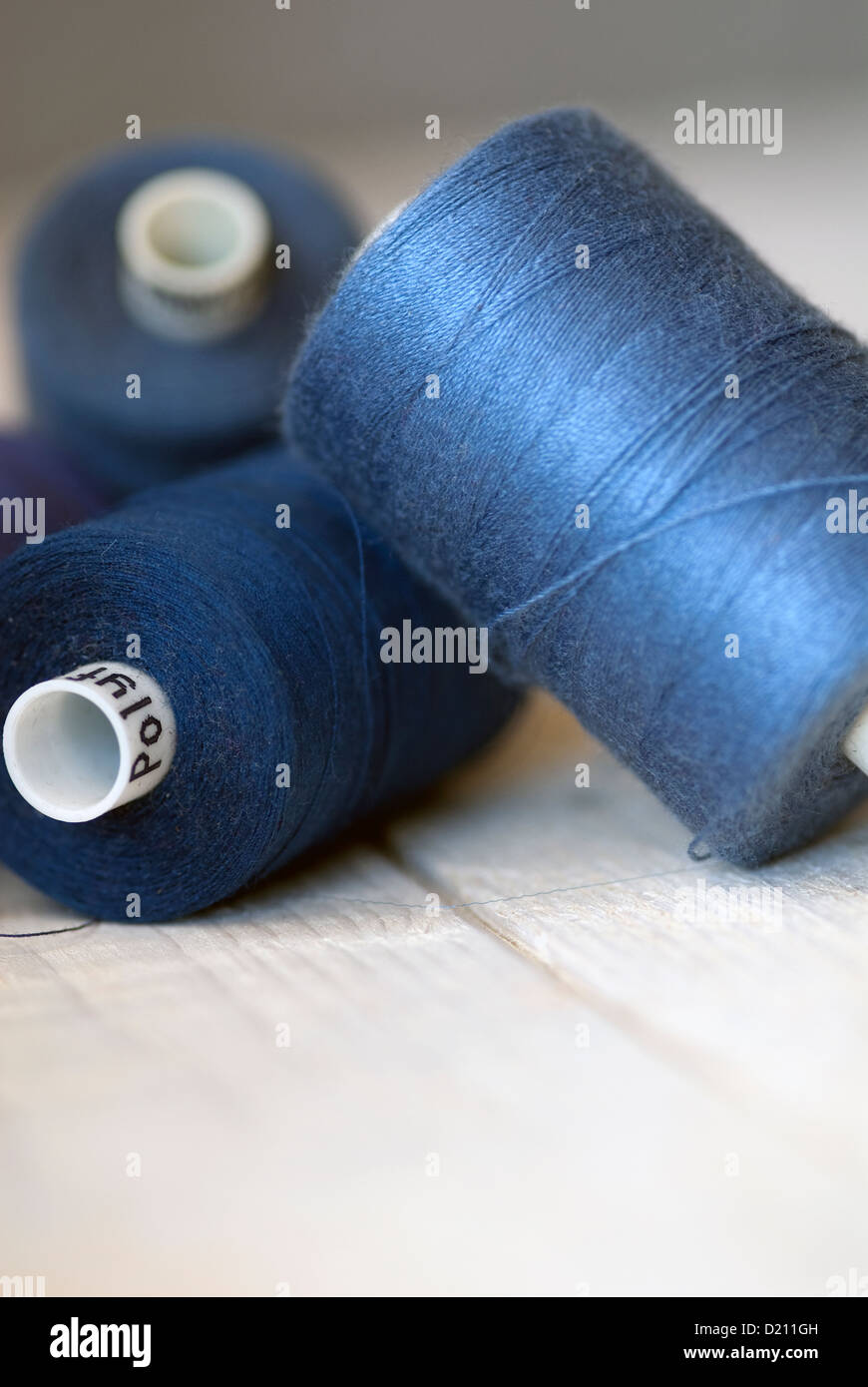 Blue thread. Set of sewing thread coils on white natural fabric with  embroidery. Several reels of thread in different shades of blue. Selective  focus Stock Photo - Alamy