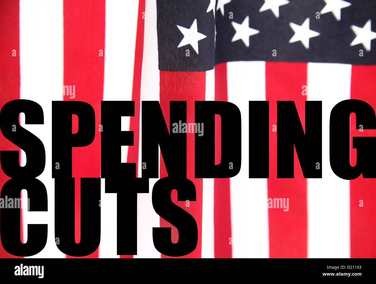 the words 'spending cuts' on an American flag background Stock Photo