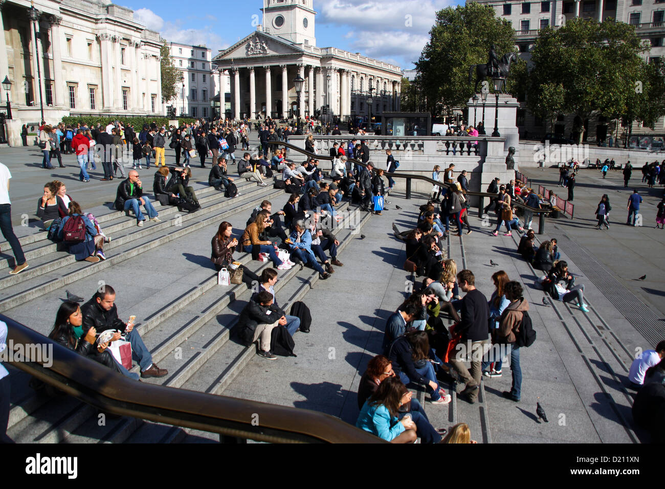 Office workers and tourists having lunch on steps in front of National