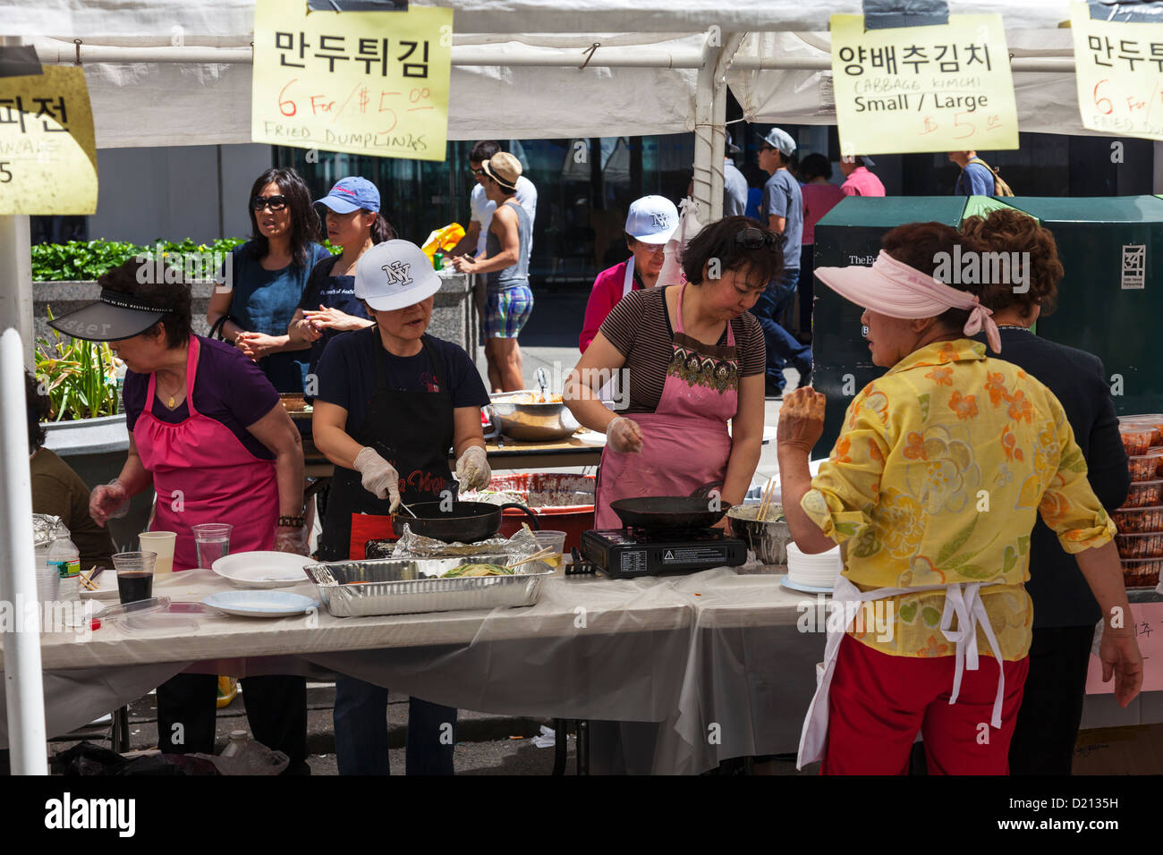 Japanese ladies cooking outside traditional food at market in new York