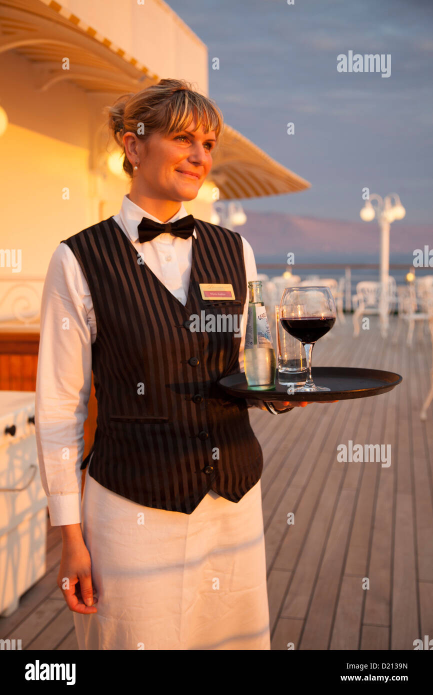 Golden waitress Maria aboard cruise ship MS Deutschland, Reederei Peter Deilmann, South Pacific Ocean, near Chile, South America Stock Photo
