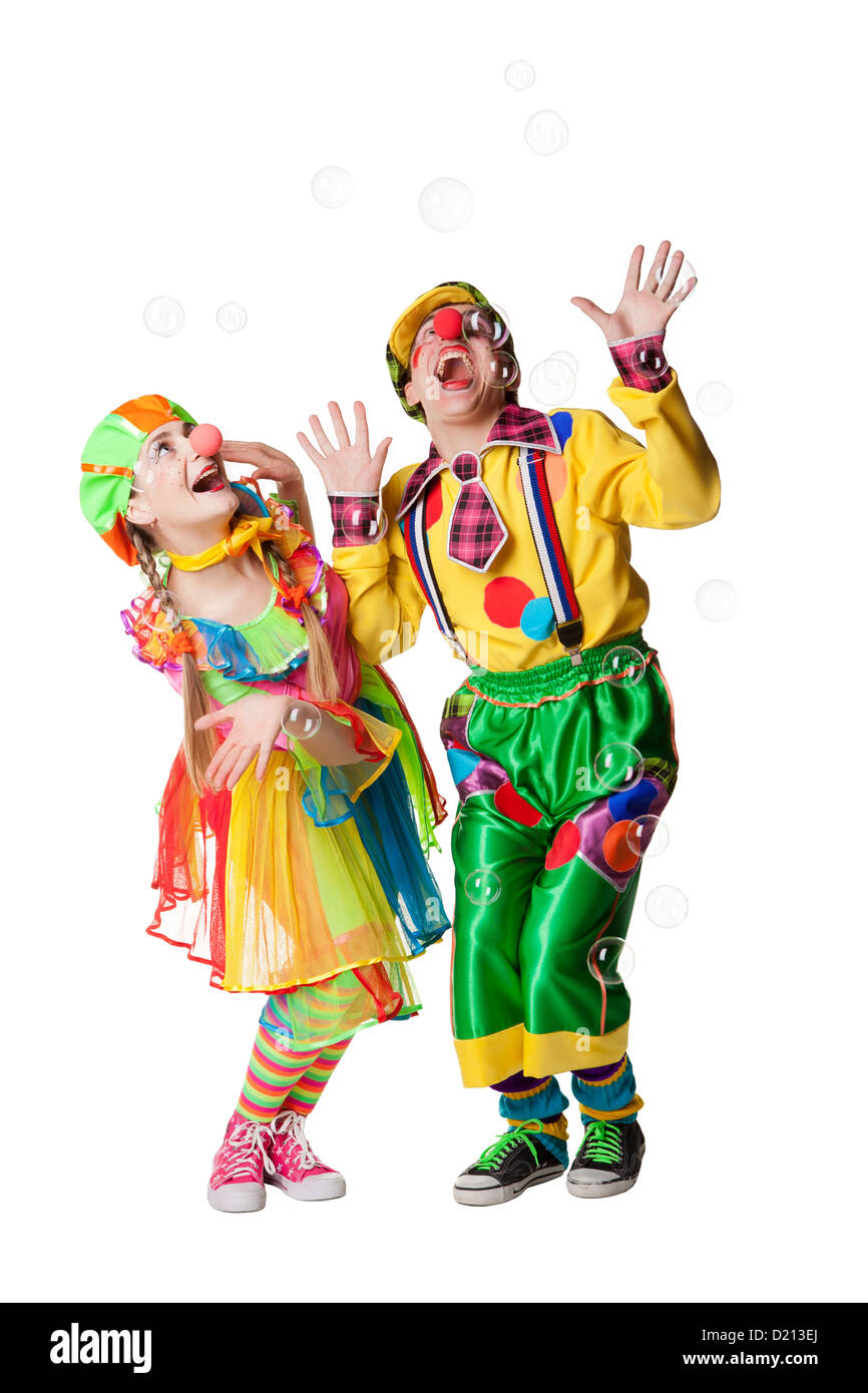Two cheerful clowns in the soap bubbles isolated on a white background ...