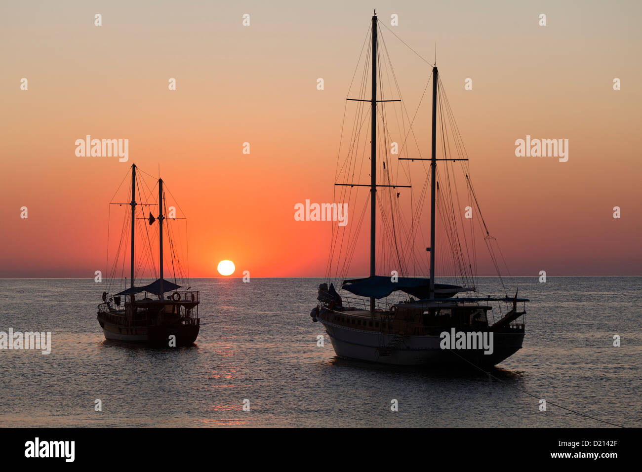 Sailing boats at sunrise at sea, Cirali, Mediterranean Sea, Lykia, Turkey Stock Photo