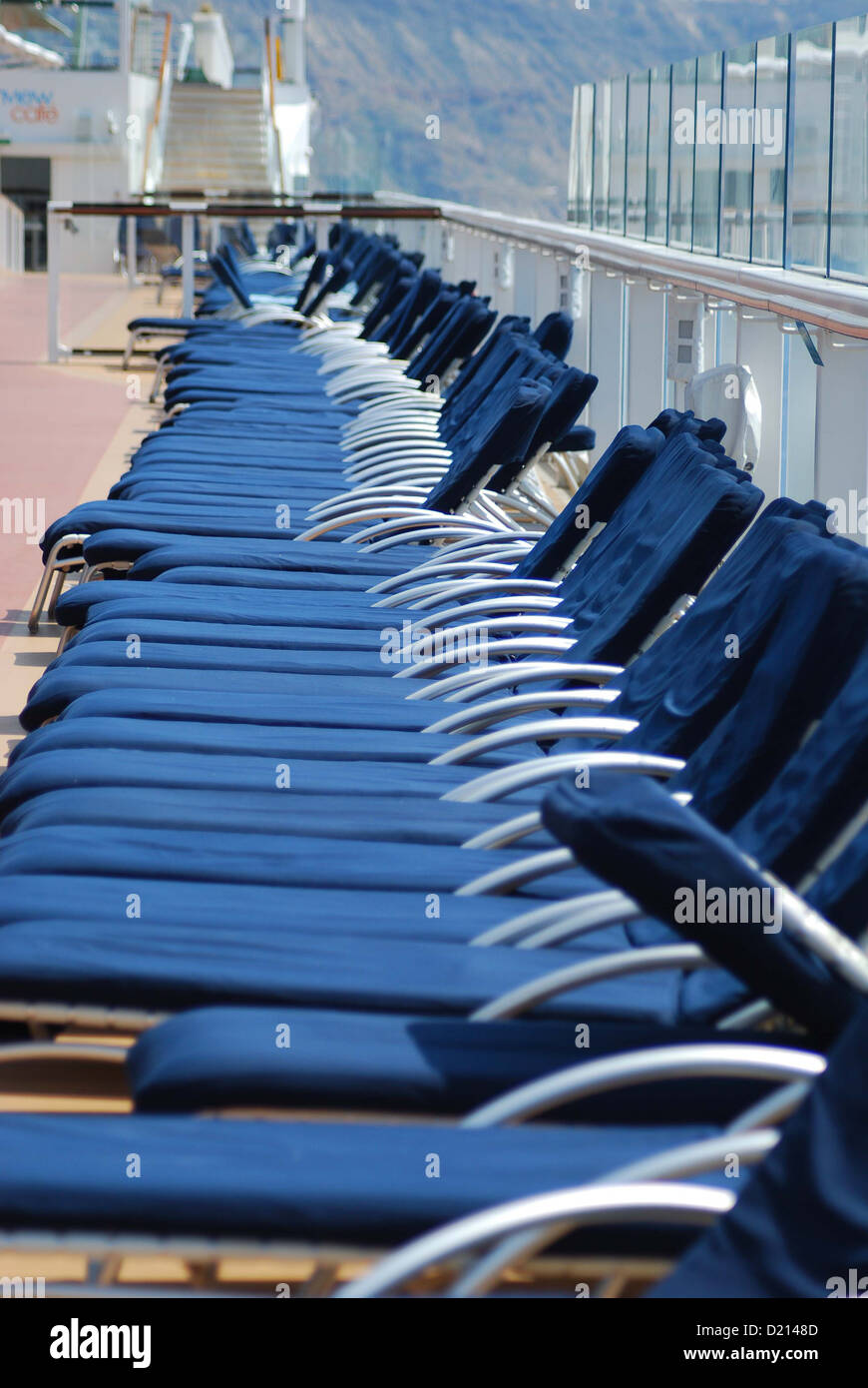 Row of lounge chairs on cruise ship. Stock Photo