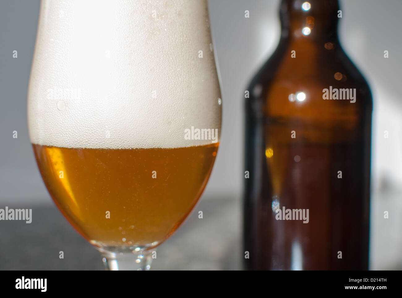 Beer glass close-up with bottle Stock Photo