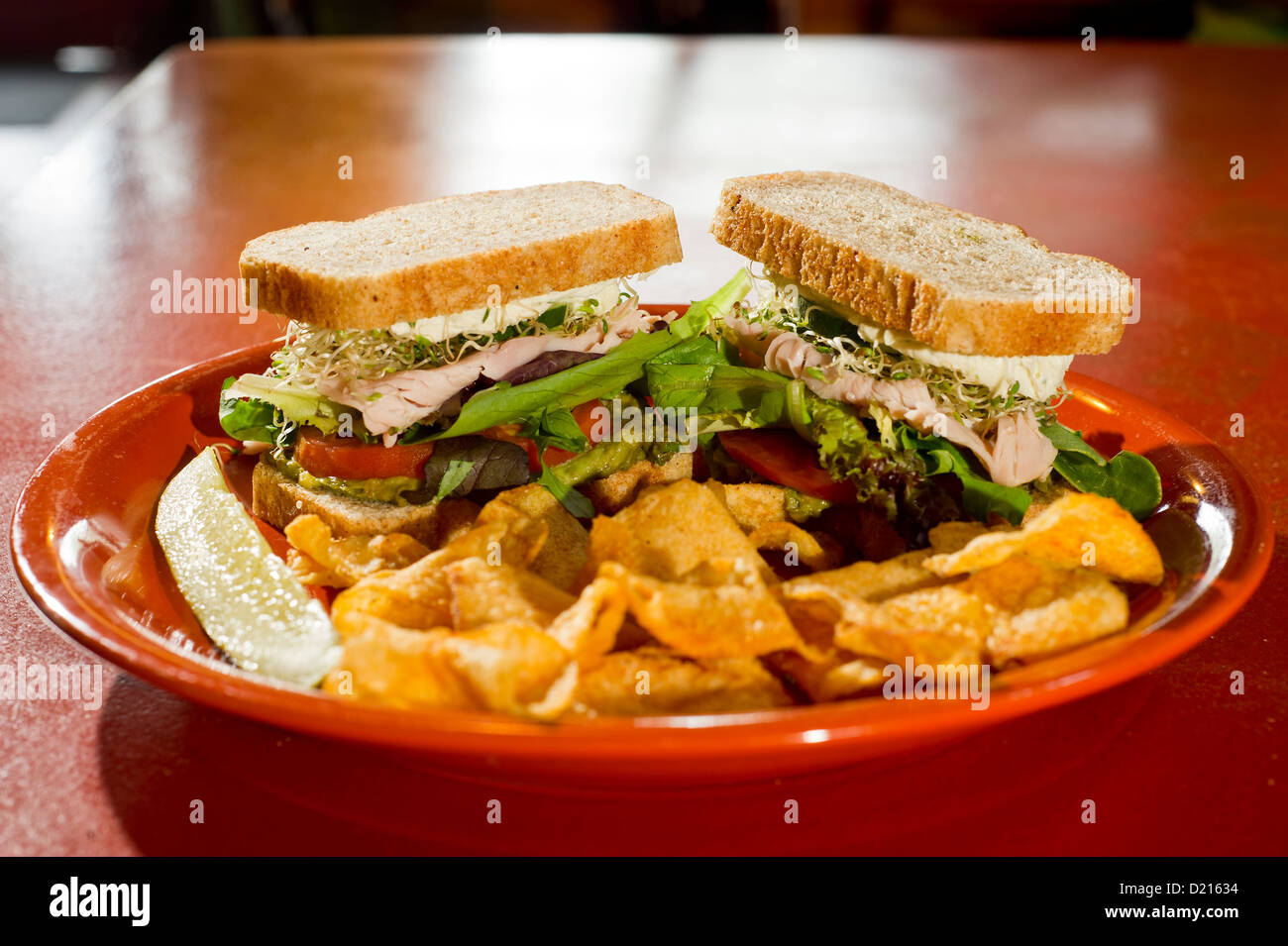 A turkey sandwich served with potato chips Stock Photo Alamy
