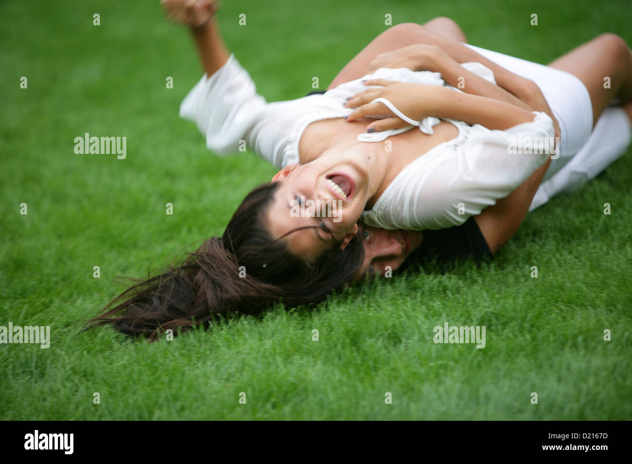 Young couple romping in meadow, Vienna, Austria Stock Photo
