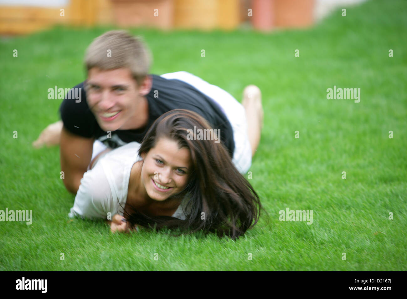 Young couple romping in meadow, Vienna, Austria Stock Photo