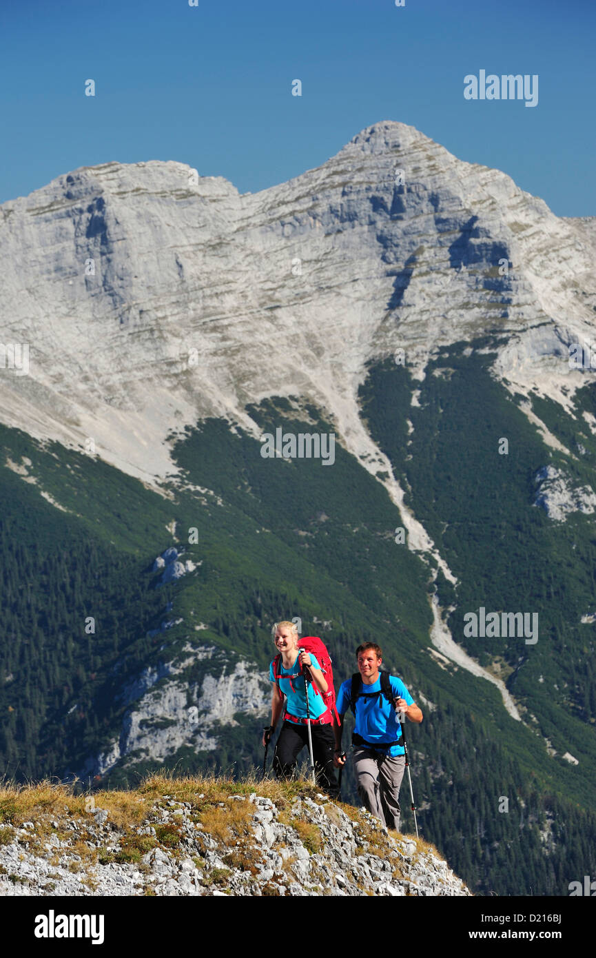 Young woman and young man hiking, Guffert in background, Unnutz, Brandenberg Alps, Tyrol, Austria Stock Photo
