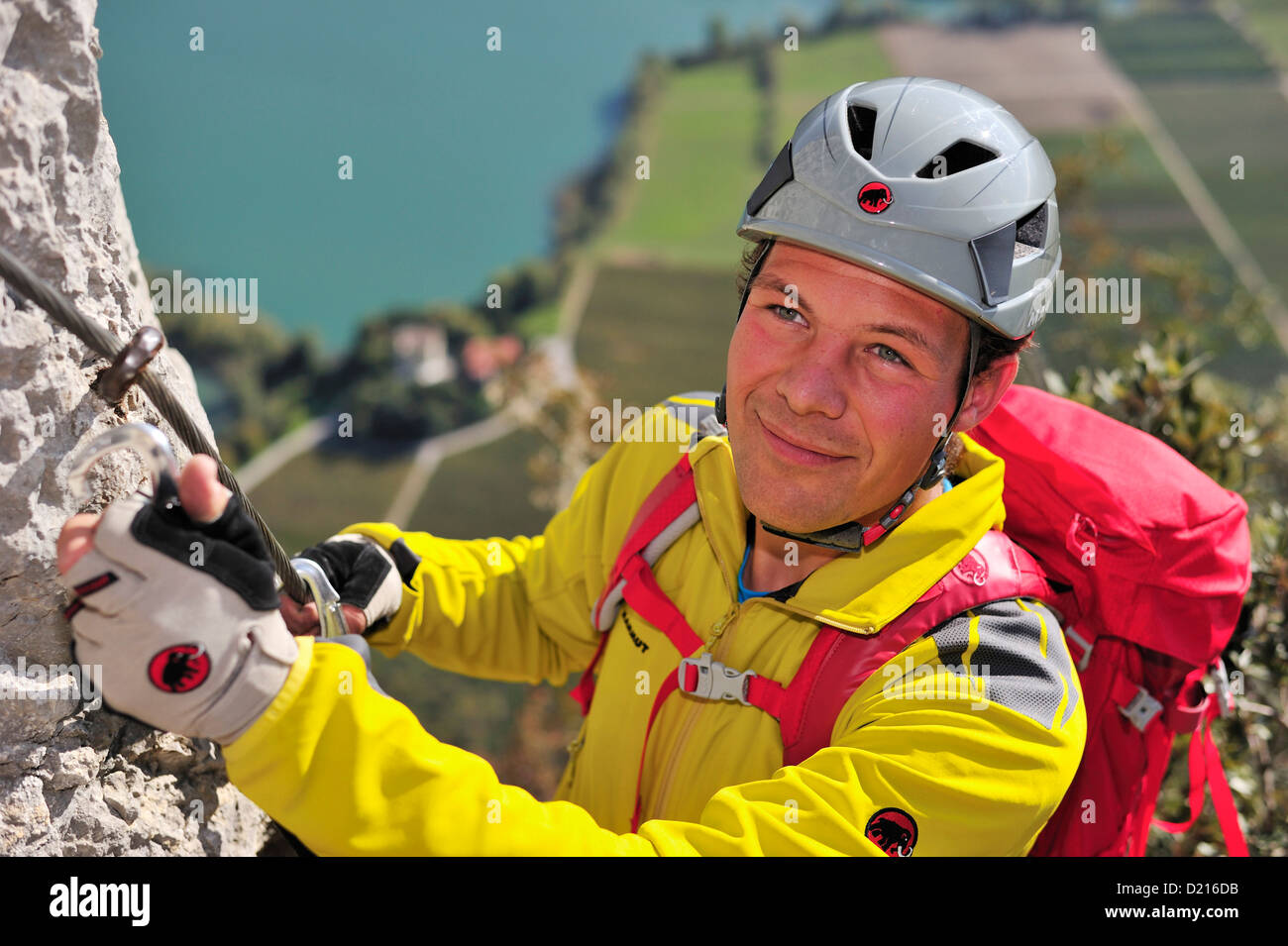 Young man at fixed rope route Rino Pisetta, Lago die Toblino, Sarche, Calavino, Trentino, Trentino-Alto Adige, Suedtirol, Italy Stock Photo