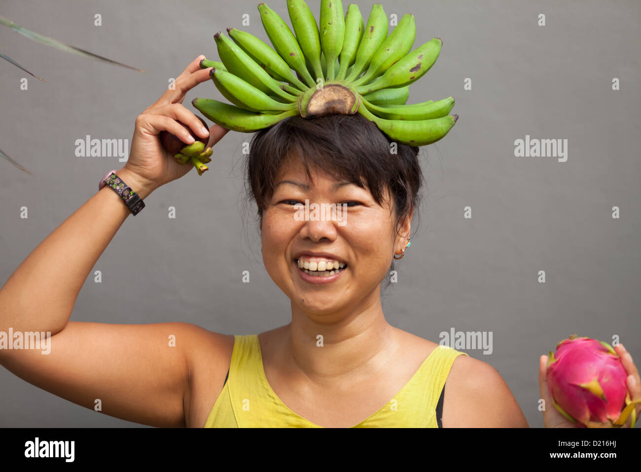 Happy and healthy woman with banana crown on her head Stock Photo