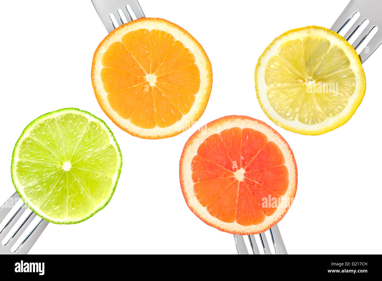 slices of citrus fruits on forks isolated against white background: lime orange grapefruit lemon Stock Photo