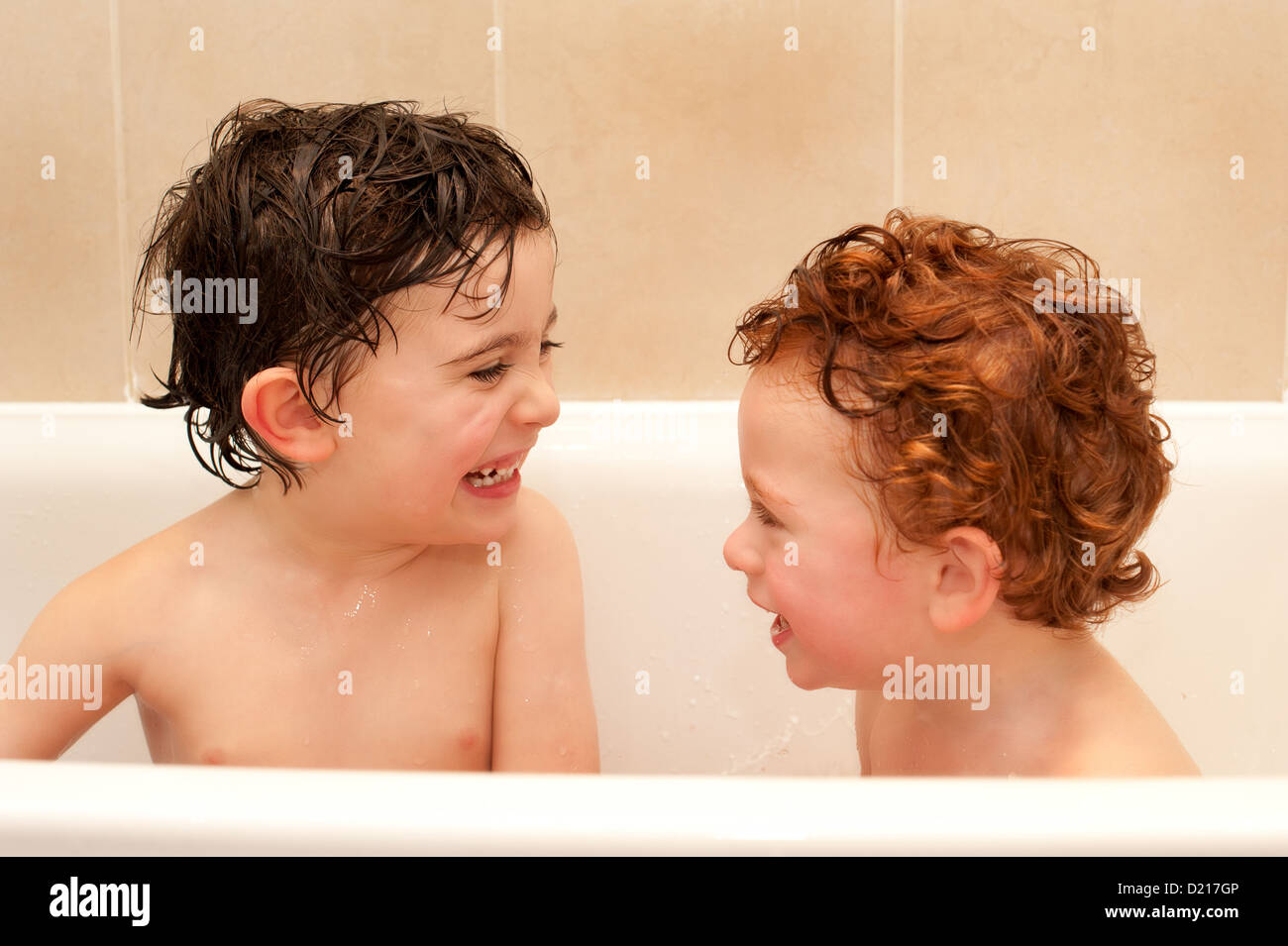 Two Happy Brothers Having Fun At Bathtime Inside Their Home They Are Smiling And Laughing Together Enjoying Life Stock Photo Alamy