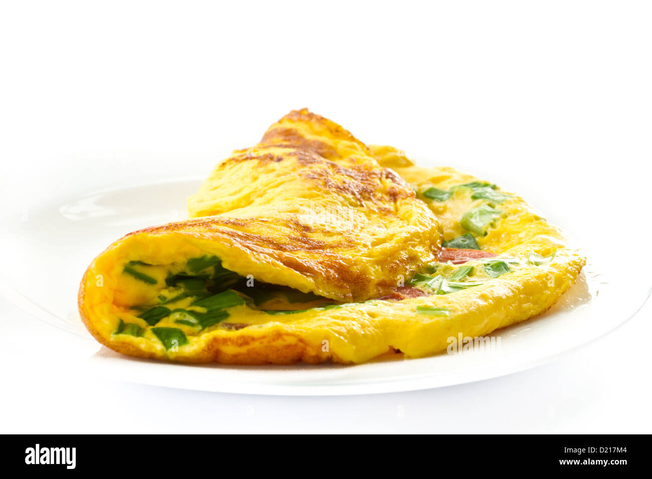 scrambled eggs with fresh herbs on a white background Stock Photo