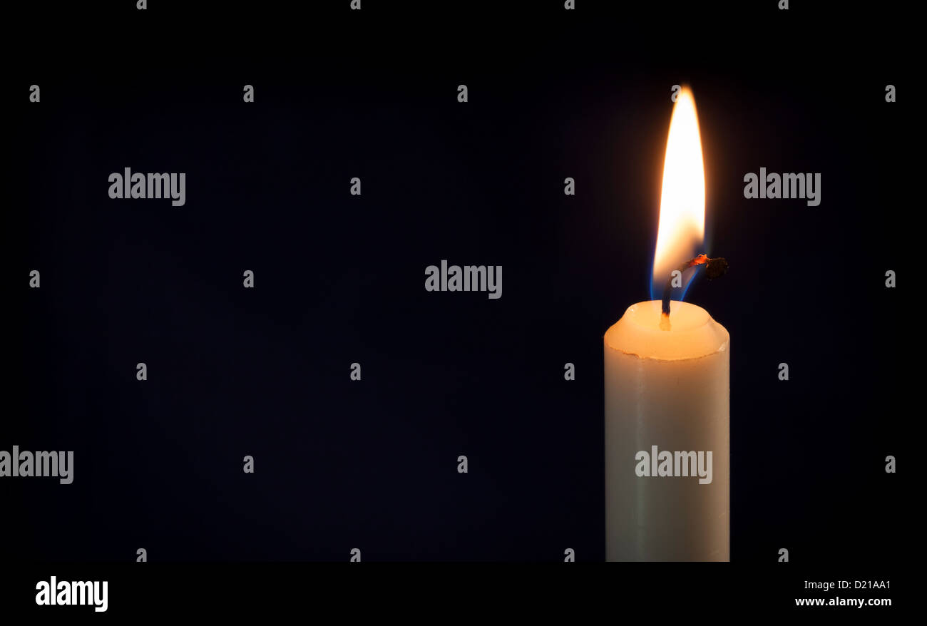 A Lit candle in the dark Stock Photo Alamy