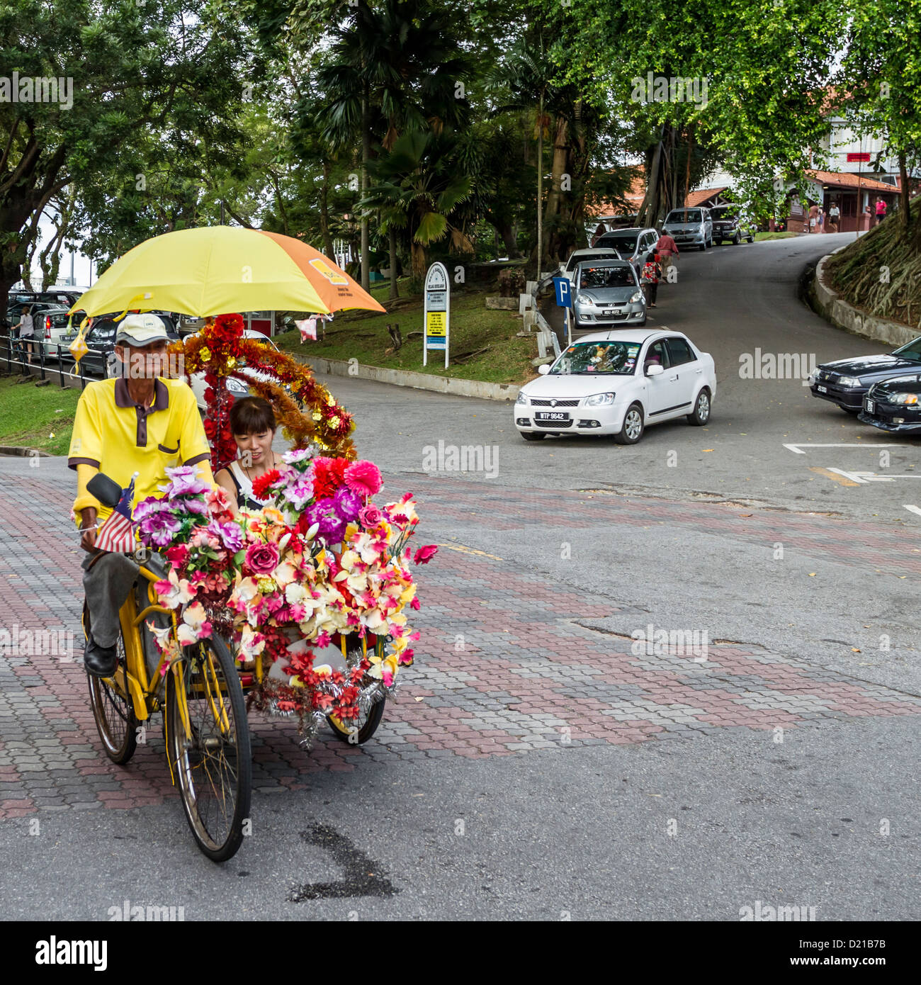 Tourists on trishaw ride in Melaka, Malaysia, are a popular tourist attraction Stock Photo