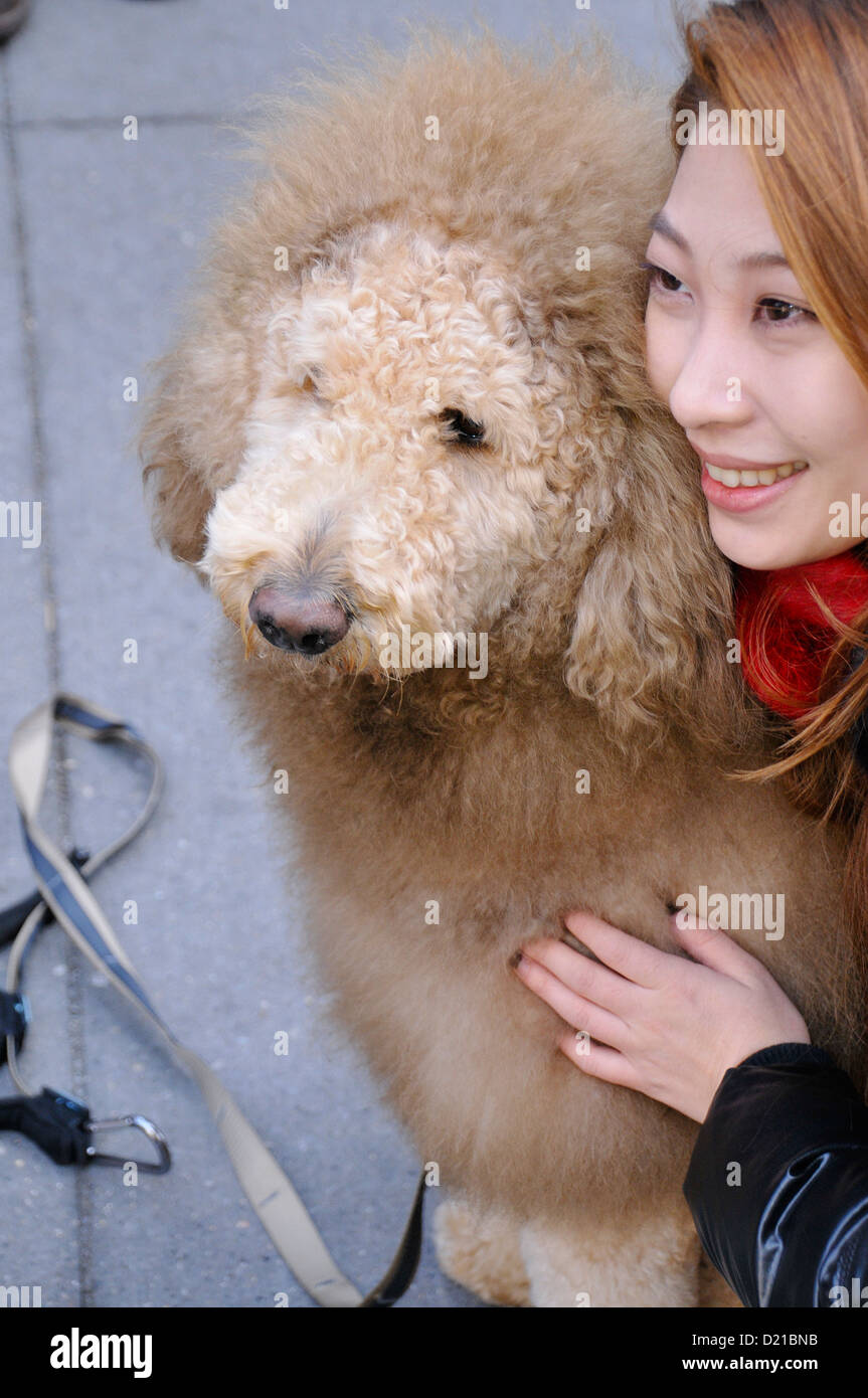 Tourist posing with Charles the Lion Dog. EDITORIAL USE ONLY. NO COMMERCIAL USES. Stock Photo