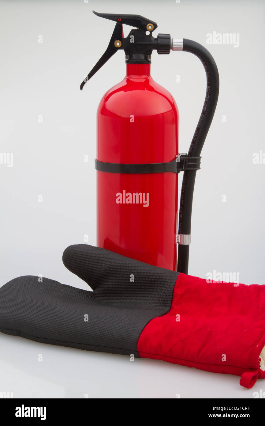 Fire retention glove next to a red fire extinguisher Stock Photo Alamy