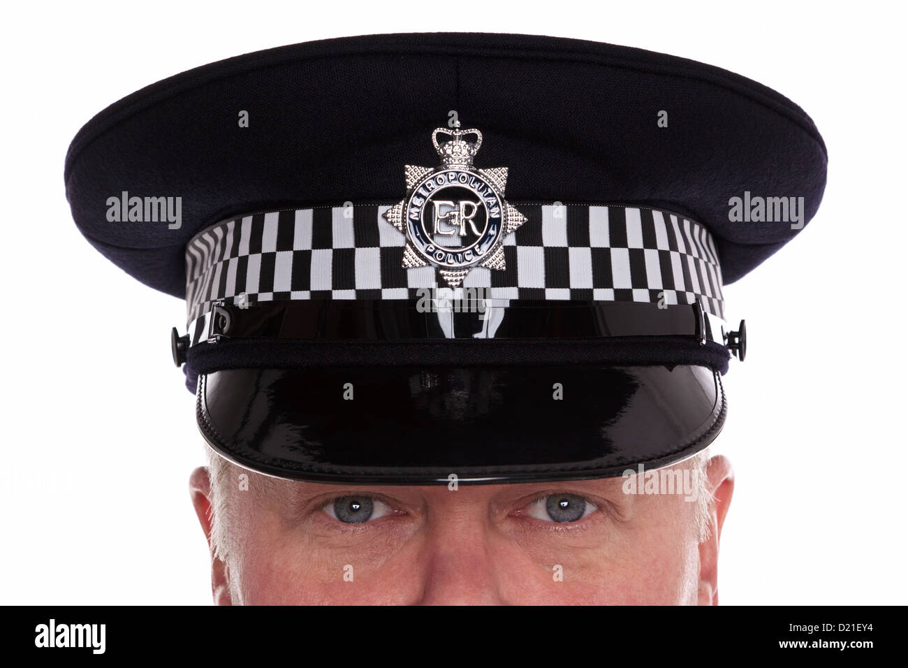 Close Up Of A British Police Officer Wearing A Flat Cap With His Eyes