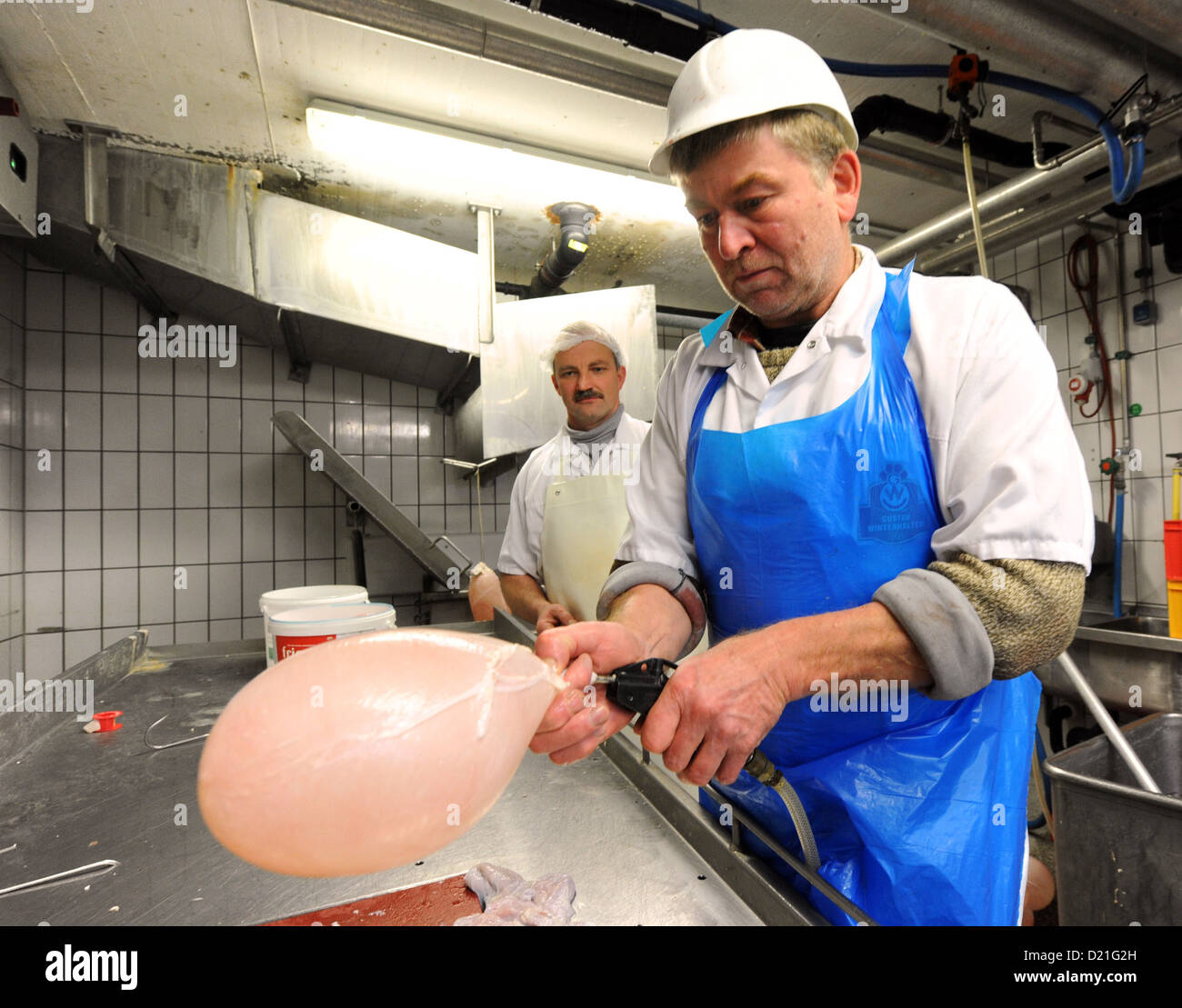 Butcher Hermann Disch from butcher's shop Winterhalter fills up pig bladders with air in Elzach, Germany, 9 January 2013. The pig bladders are used for the carnival parade. Photo: Patrick Seeger Stock Photo