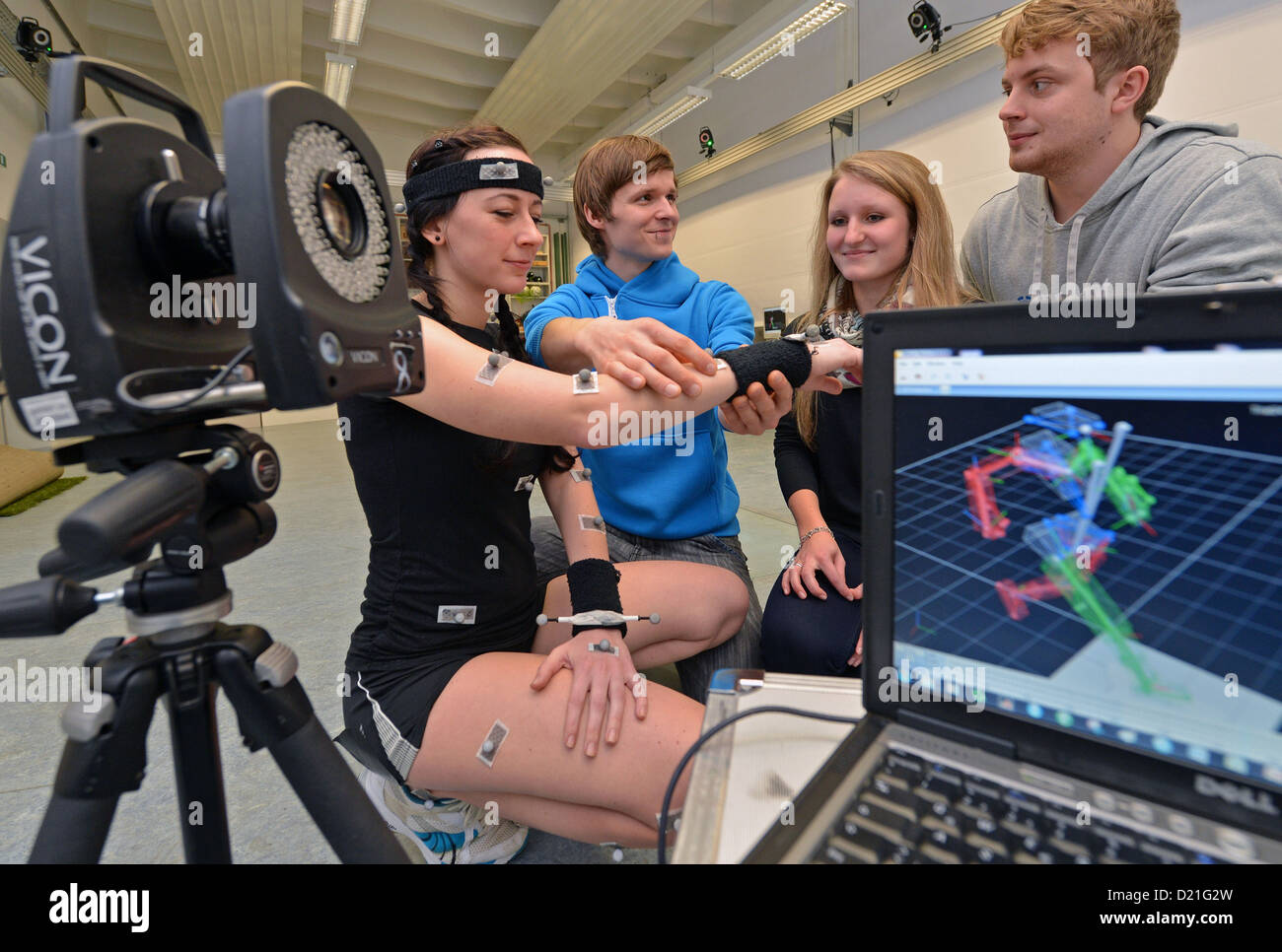 Research assistant Tobias Hess (2-L) explains a Kinesiology study which allows the creation of a 3D model during the open house day at the Technical University in Chemnitz, Germany, 10 January 2013. Photo: HENDRIK SCHMIDT Stock Photo