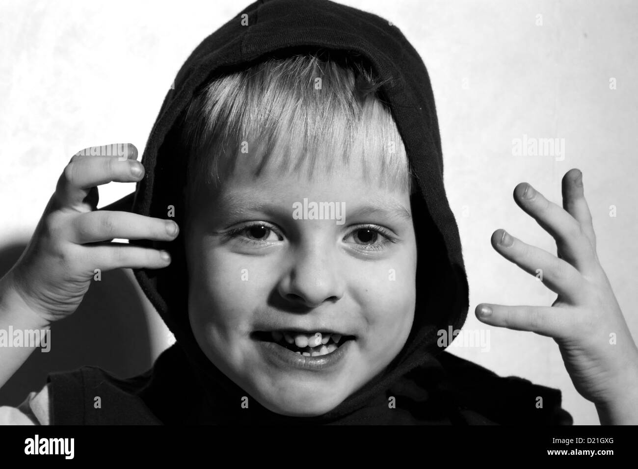 black and white photo of Laughing boy in the hood Stock Photo