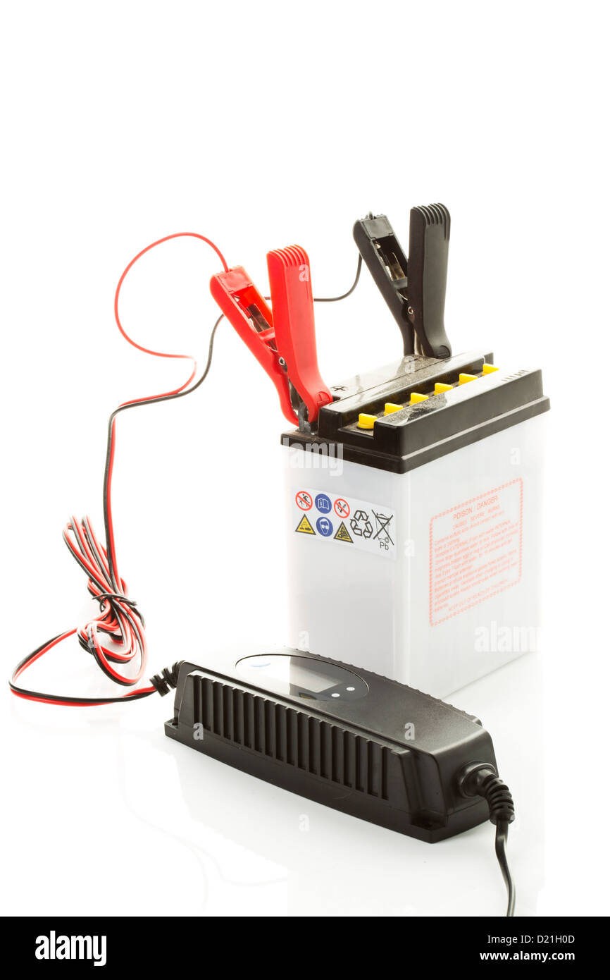 Car battery with charger on white background Stock Photo Alamy