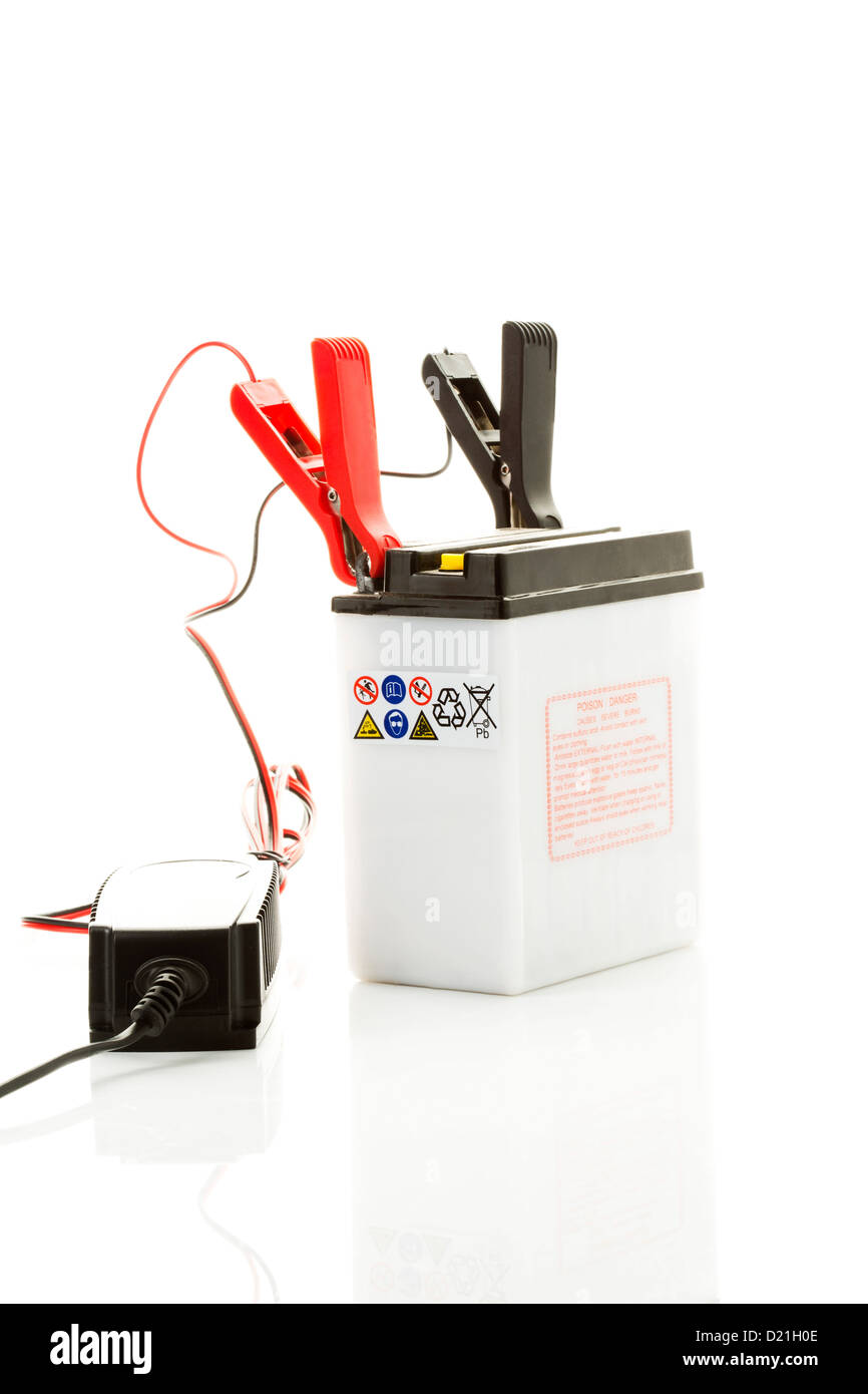 Car battery with charger on white background Stock Photo Alamy