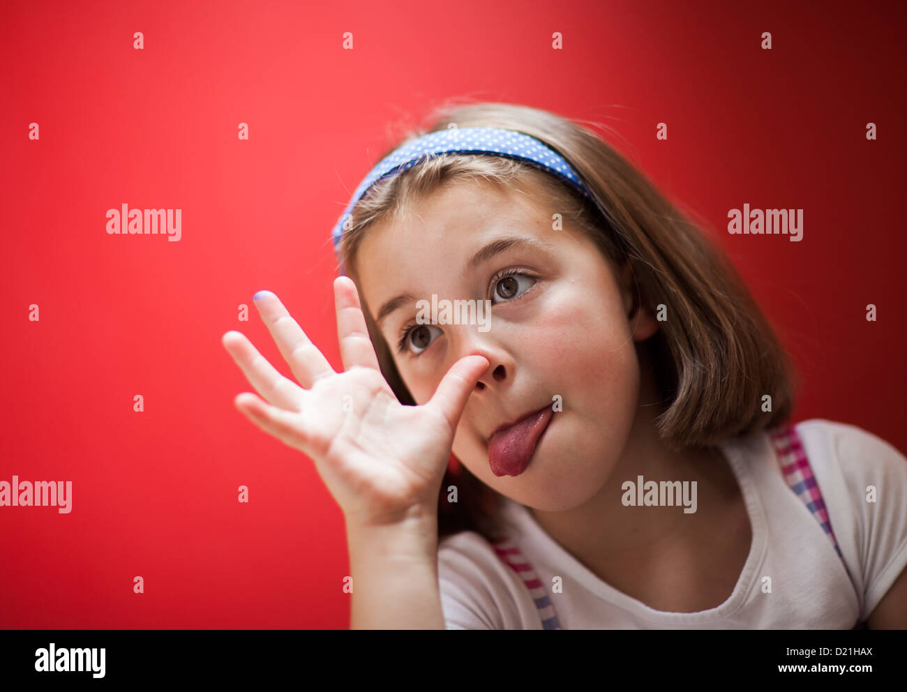 A young girl pulling a funny face and sticking her tongue out Stock