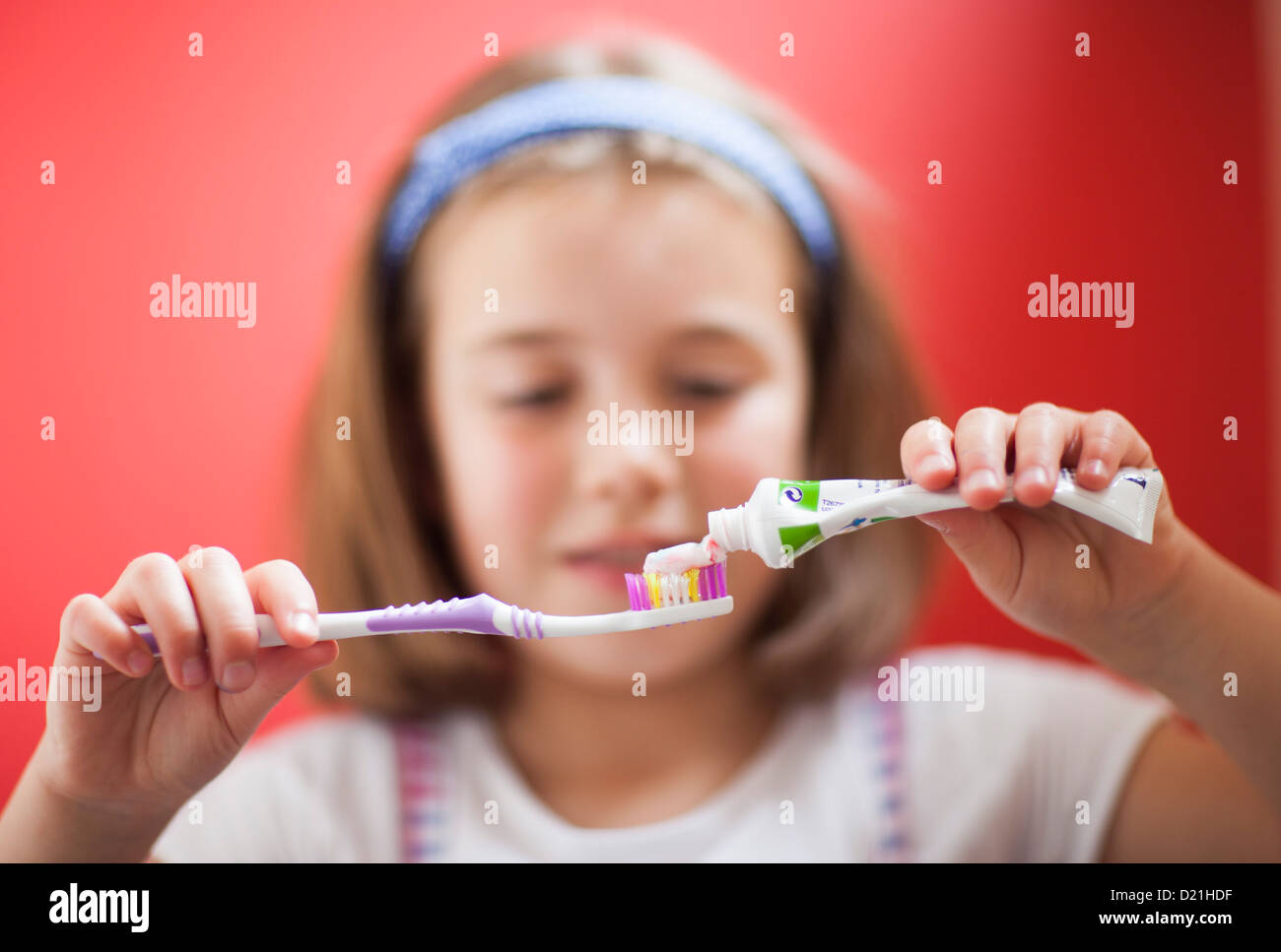 putting toothpaste on toothbrush