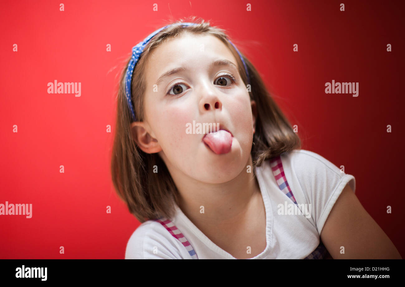 A young girl sticking her tongue out Stock Photo