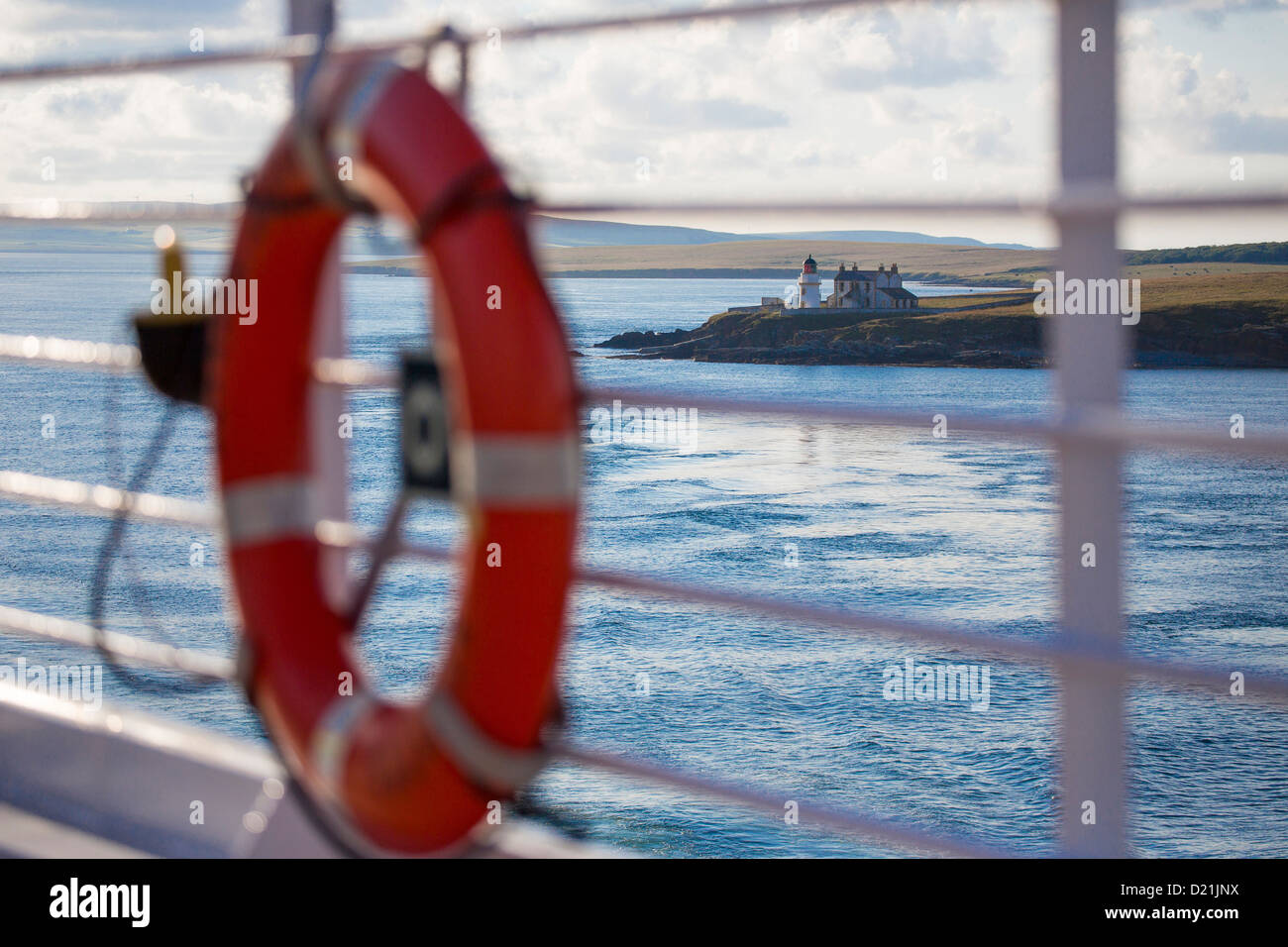 Lifering aboard cruise ship Azamara Journey, Azamara Club Cruises and Lighthouse of the Graad, Egilsay Island, Orkney Islands, S Stock Photo