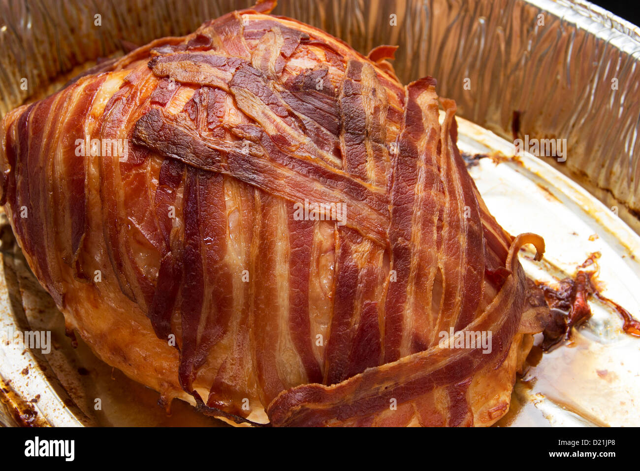 A cooked turkey crown covered in bacon Stock Photo
