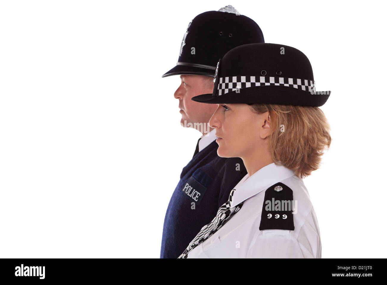 Studio shot of male and female British Police officers in traditional uniform profiles. Stock Photo