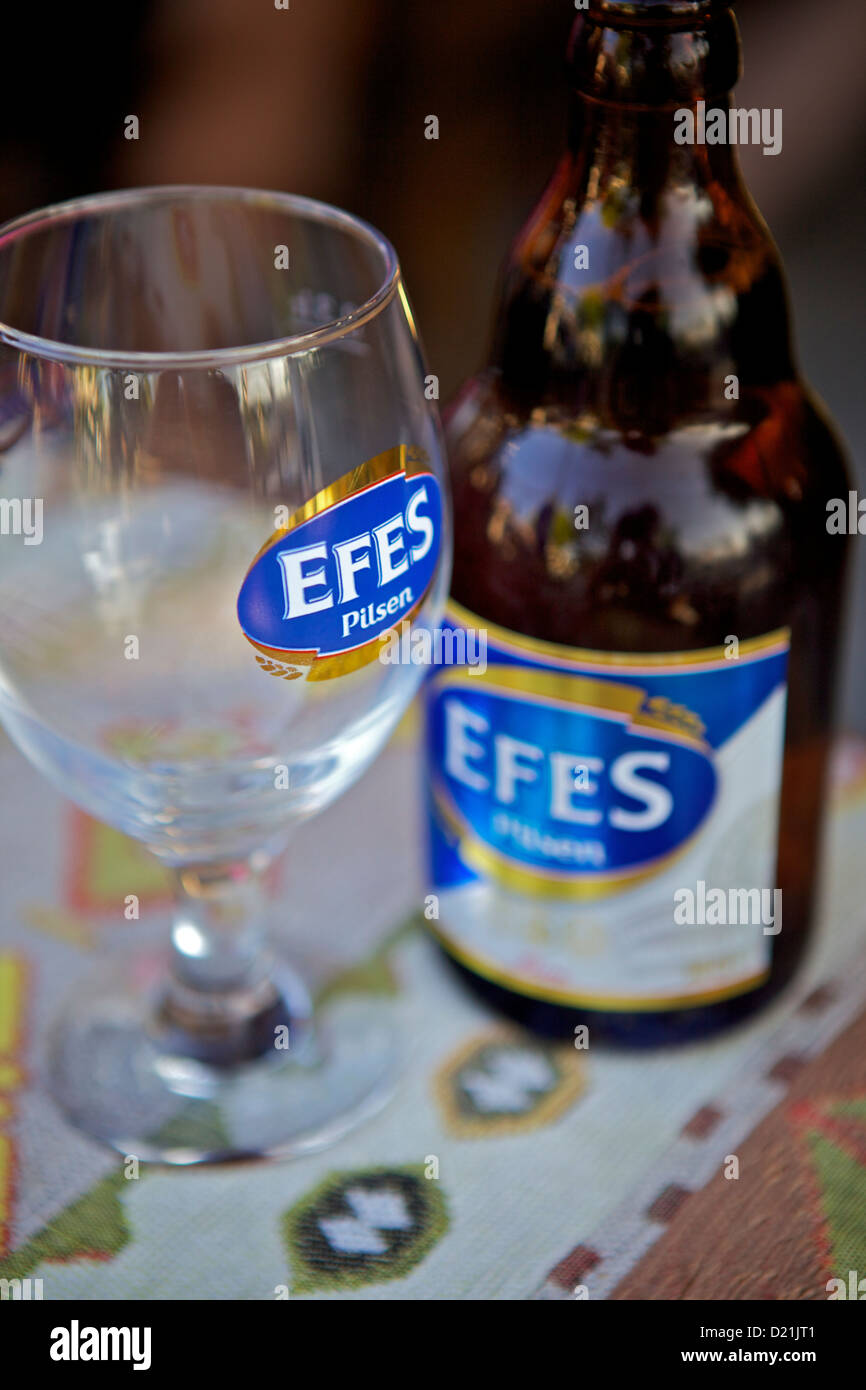 Efes Pilsen Beer Bottle and Glass on restaurant Table in Side, Turkey Stock Photo