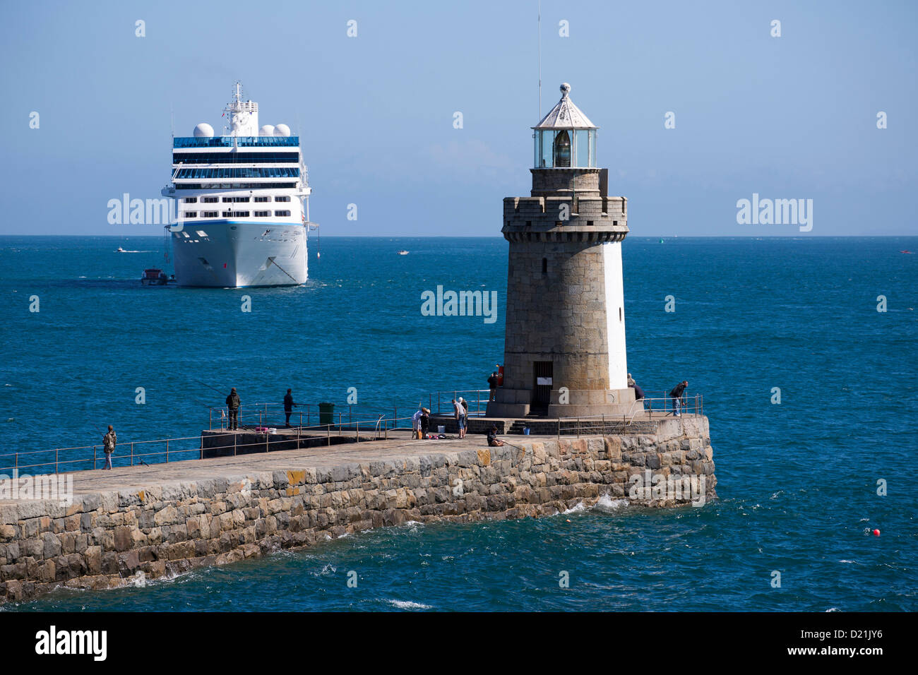 Lighthouse on jetty and cruise ship Azamara Journey, Azamara Club Cruises, at anchor, St Peter Port, Guernsey, Channel Islands, Stock Photo