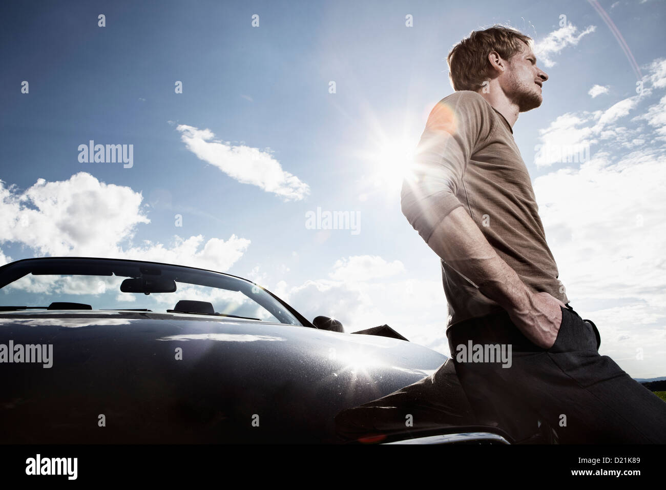 Germany, Bavaria, Mid adult man standing by car Stock Photo