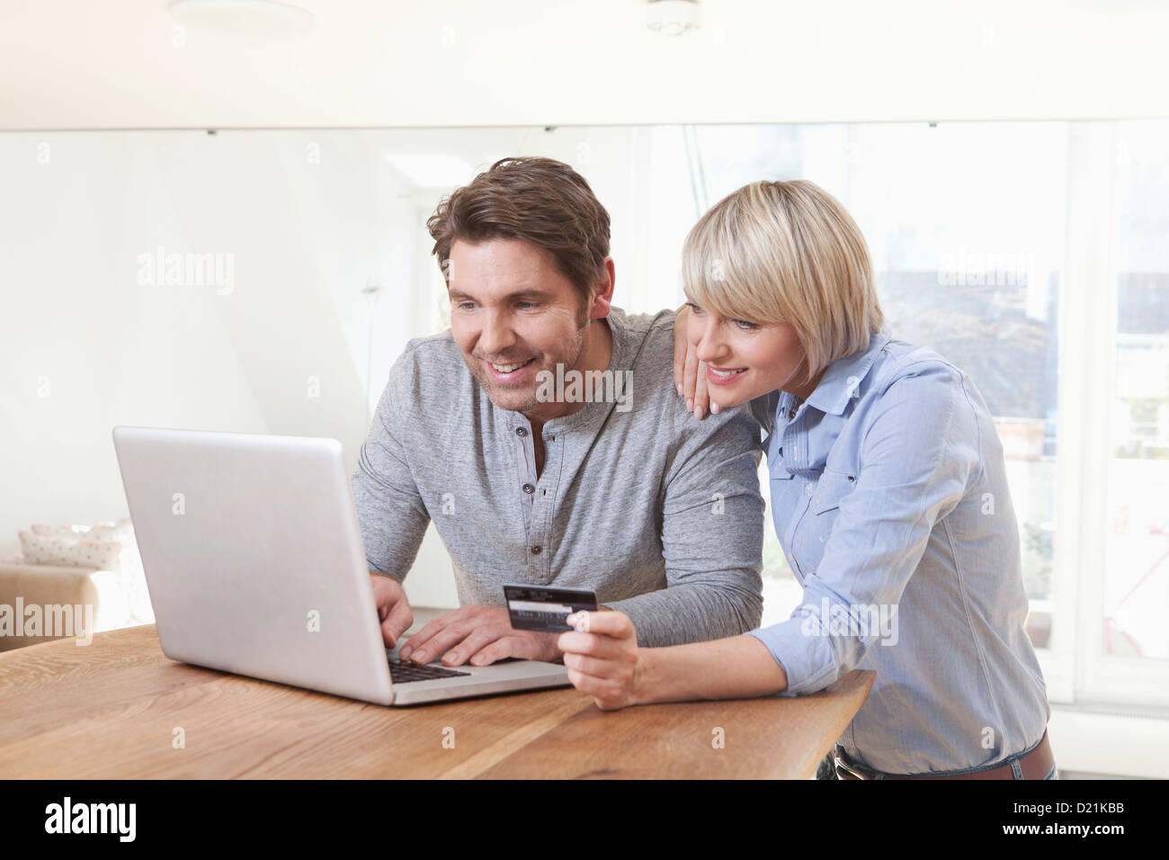 Germany, Bavaria, Munich, Mature couple shopping with credit card on laptop Stock Photo