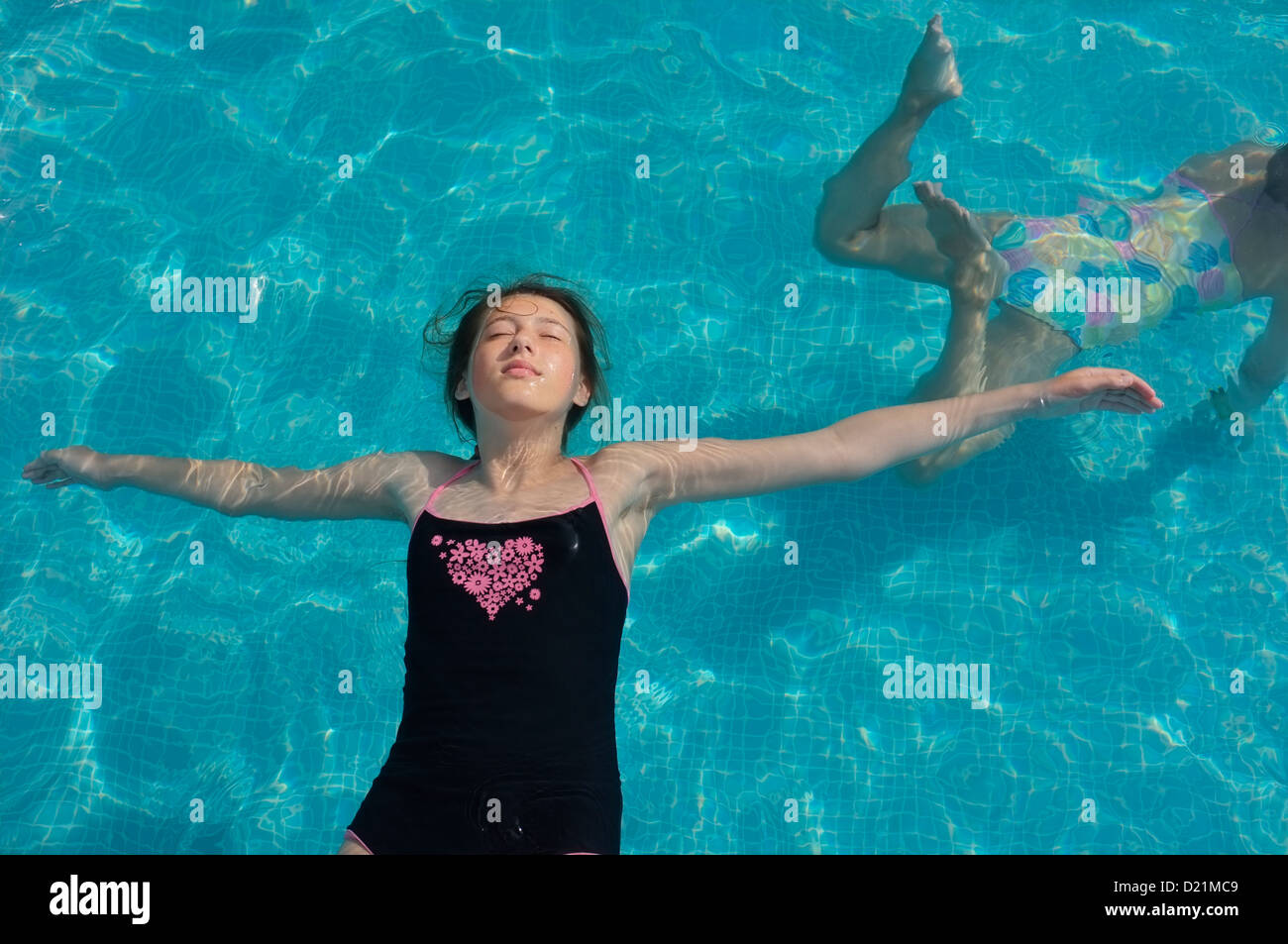 A 12 year old girl enjoying being in a swimming pool Stock Photo Alamy