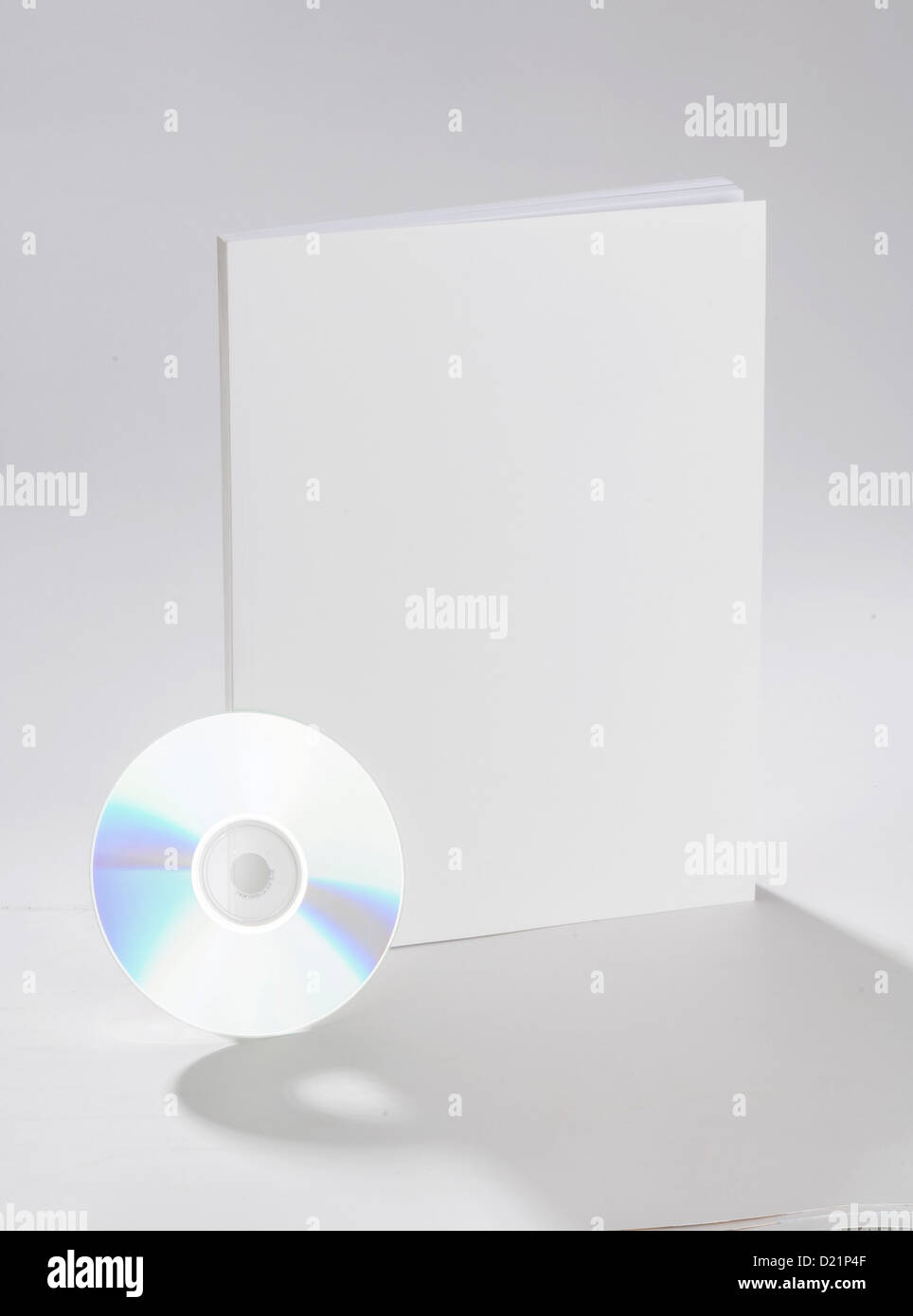 Blank CD and book on white ground Stock Photo - Alamy